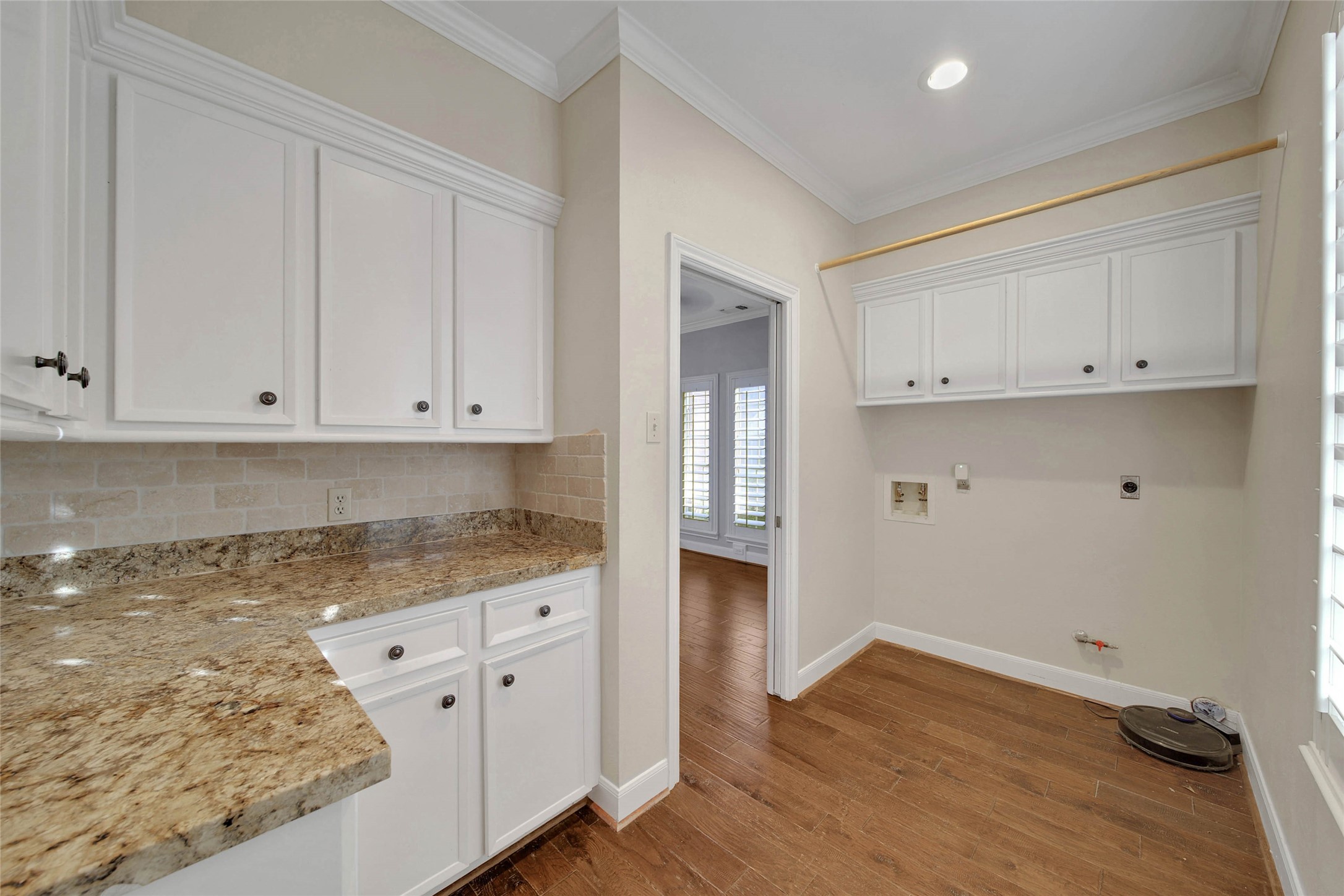 Rare Butlers Pantry / laundry / Utility room is spacious. Featuring a granite worktop for food prep, or entertaining prep, lots of cabinetry for storage of seasonal items and room for a second fridge or upright freezer too! Bright sunny window faces the street and has plantation shutters.