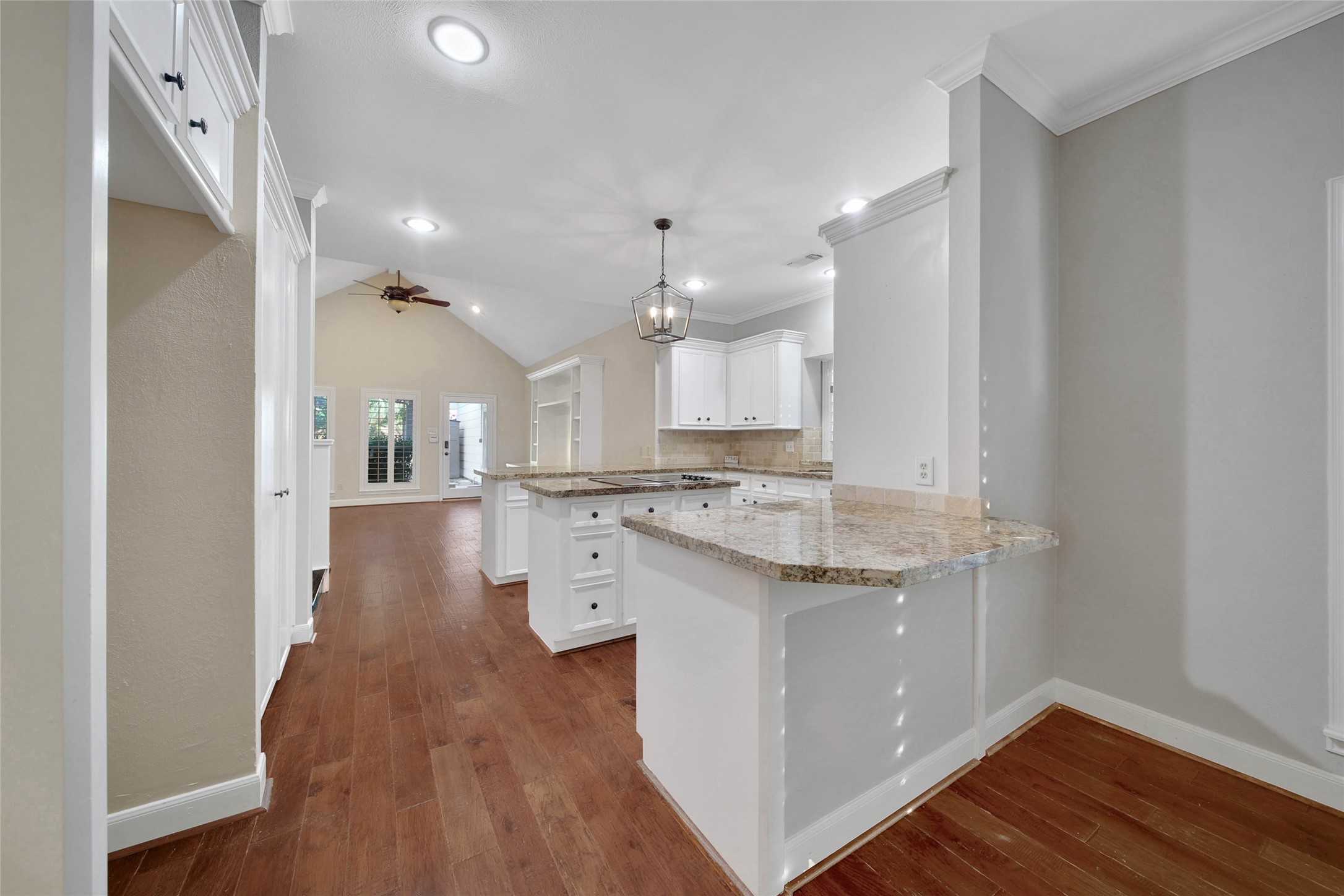 Functional kitchen features a double serving bar on each side of the kitchen.