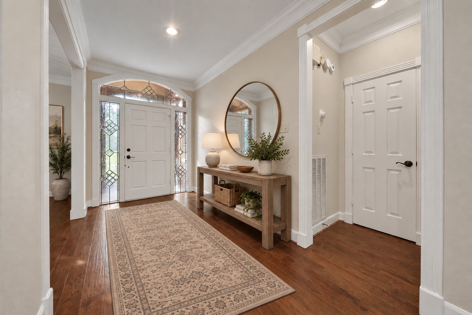 Elegant foyer with continuous hardwood floors throughout the main living area. Photo has been digitally altered using generative ai for virtual staging. Buyer to verify all.