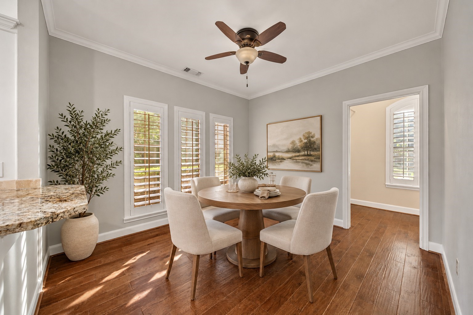 Huge breakfast room with adjacent butlers pantry / laundry utility room. Plantation shutters offer an elevated look to this functional space. Photo has been digitally altered using generative ai for virtual staging. Buyer to verify all.