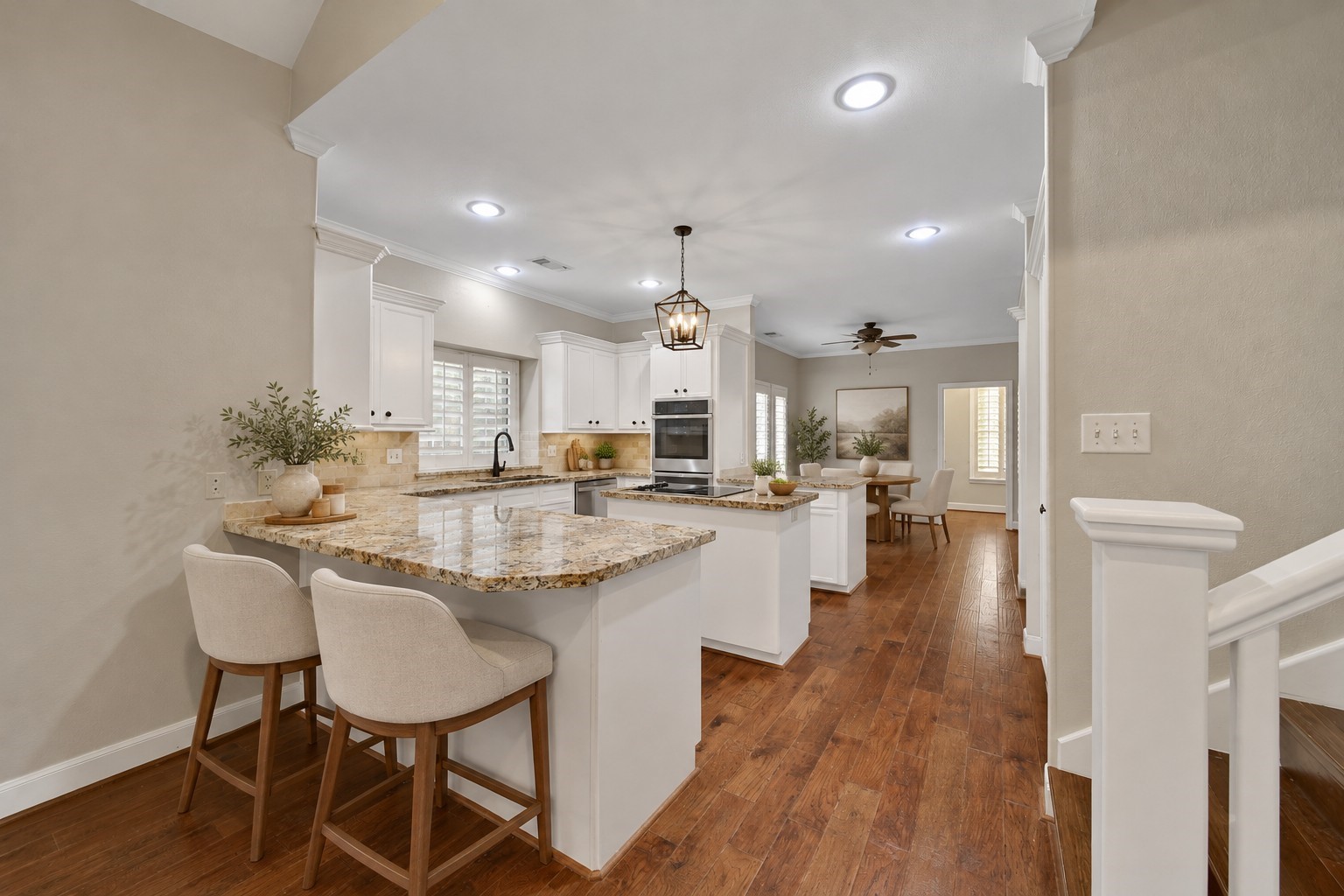 This functional kitchen serves it up, with two breakfast bars, and island cooktop, under and upper cabinet lighting, and custom built in pantry shelving, Multi-feature GE Profile double oven features convection cooking. GE Profile Dishwasher. Huge Breakfast room is adjacent to the kitchen with the butlers pantry / laundry utility room access. Photo has been digitally altered using generative ai for virtual staging. Buyer to verify all.