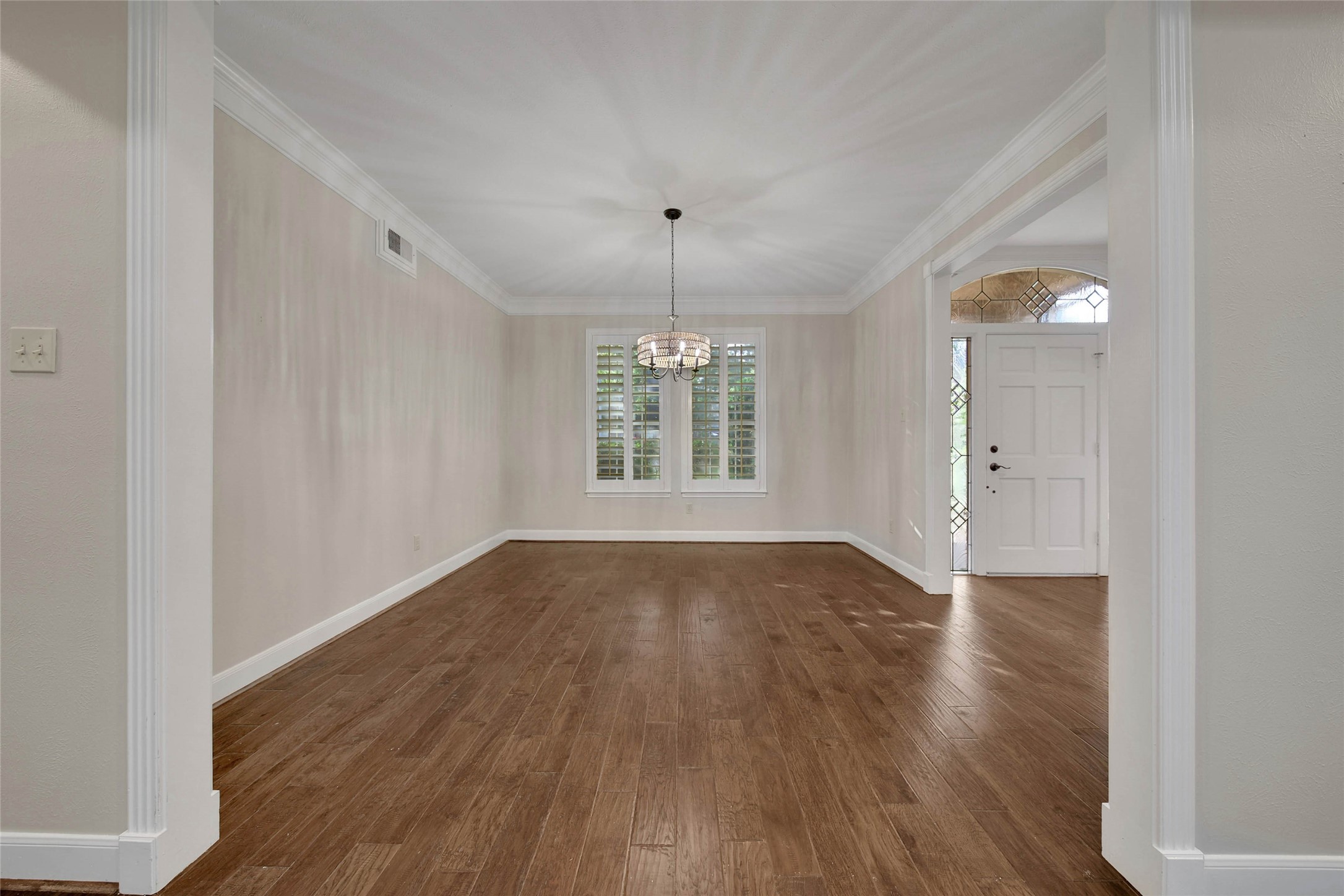 Open dining room is adjacent to the foyer and open to the main living area.