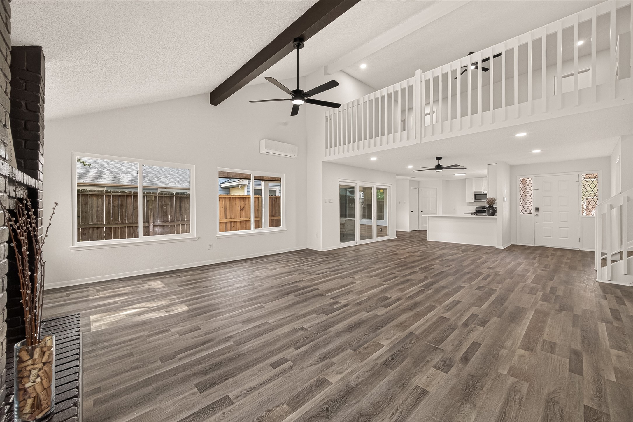 Spacious open-concept living/dining  area with exposed beams