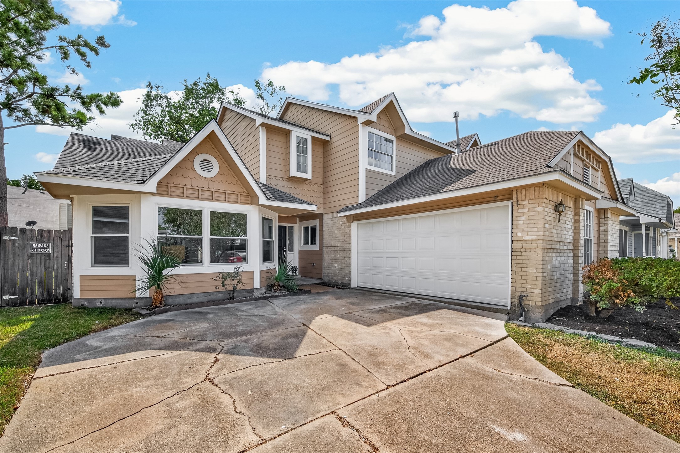 Charming two-story home with a spacious driveway and attached two-car garage, featuring a welcoming facade and landscaped front yard. Charming two-story home with a spacious driveway and attached two-car garage, featuring a welcoming facade and landscaped front yard.