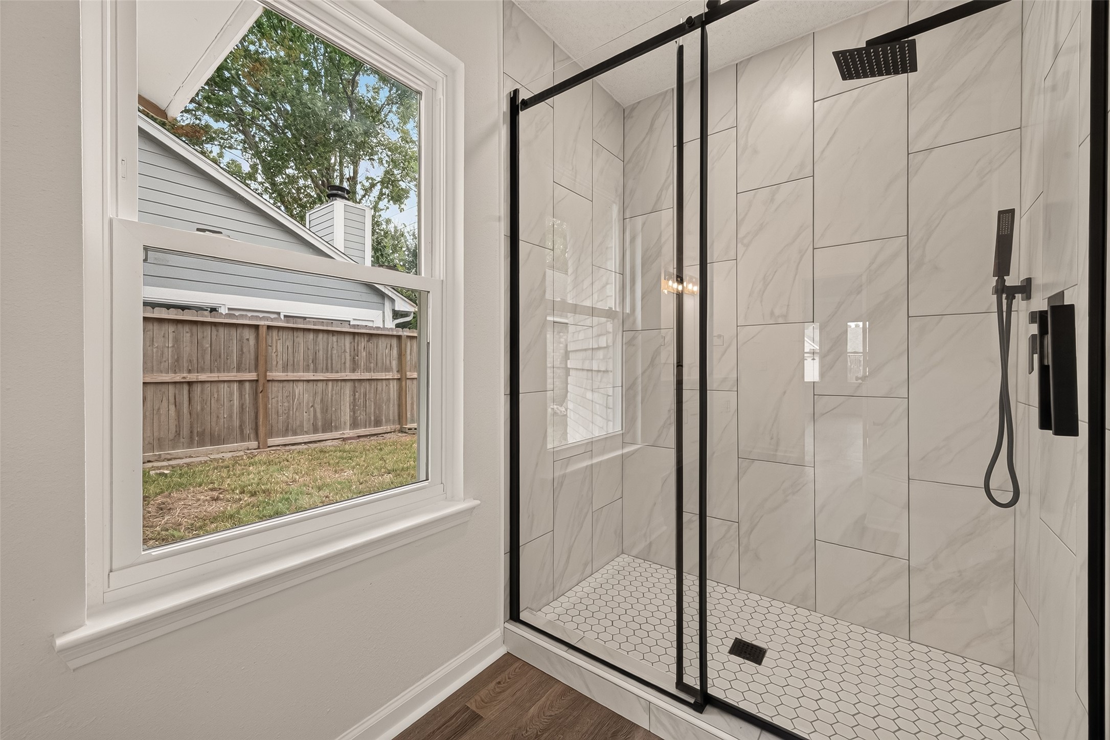 Spacious glass-enclosed shower in the primary bathroom