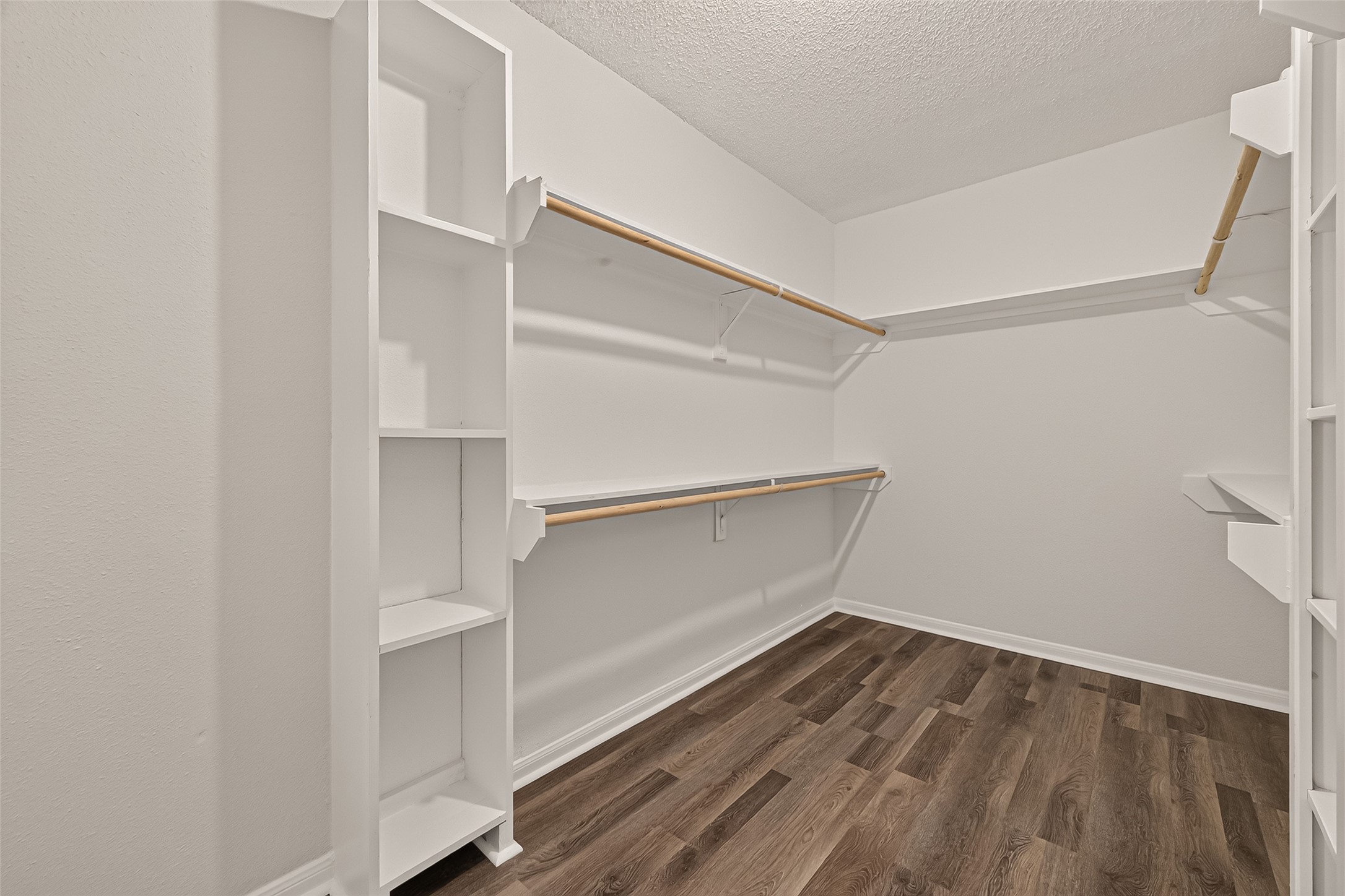 Spacious walk-in closet with ample shelving and hanging space