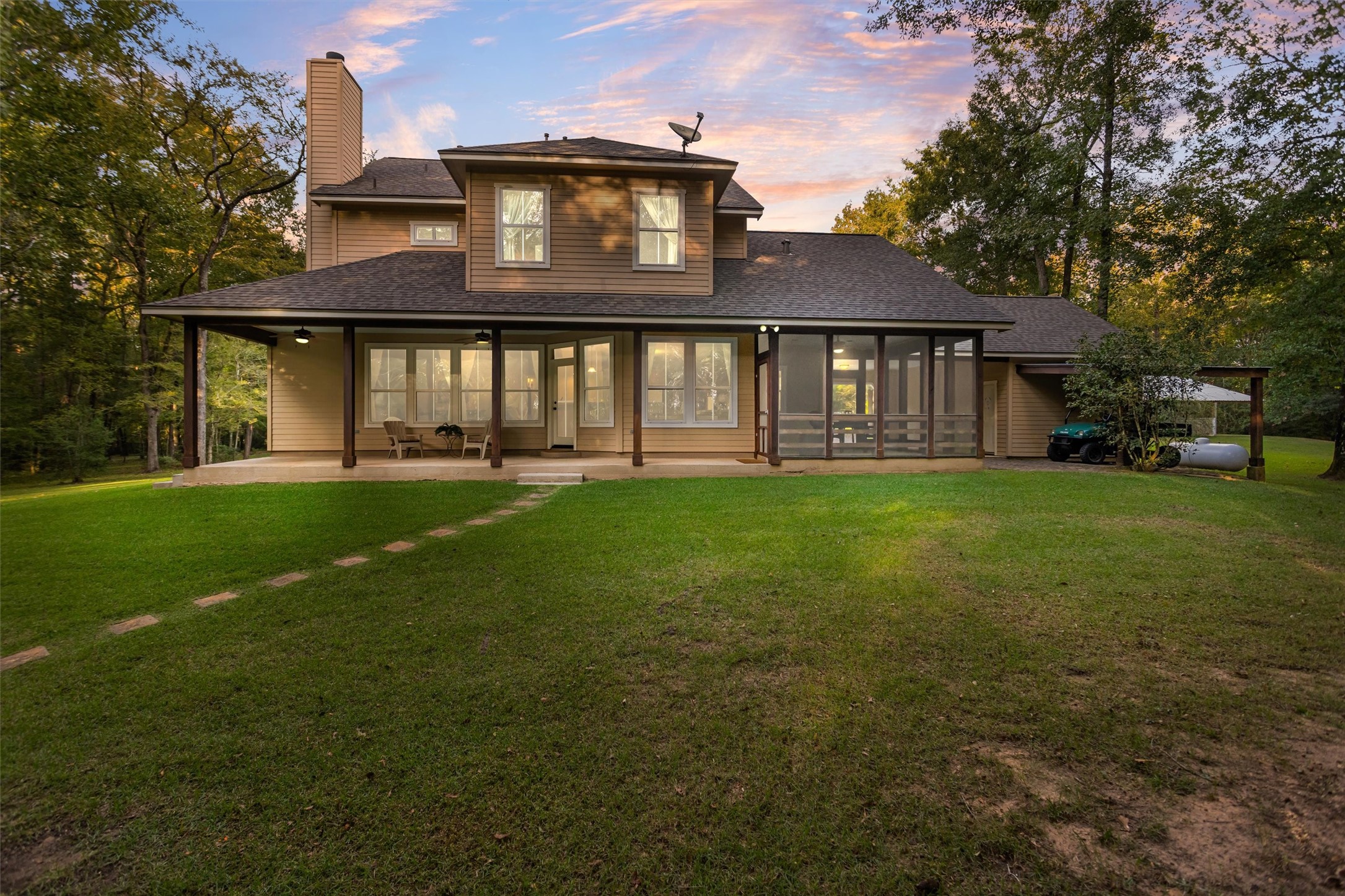The back of the home glowing at sunset