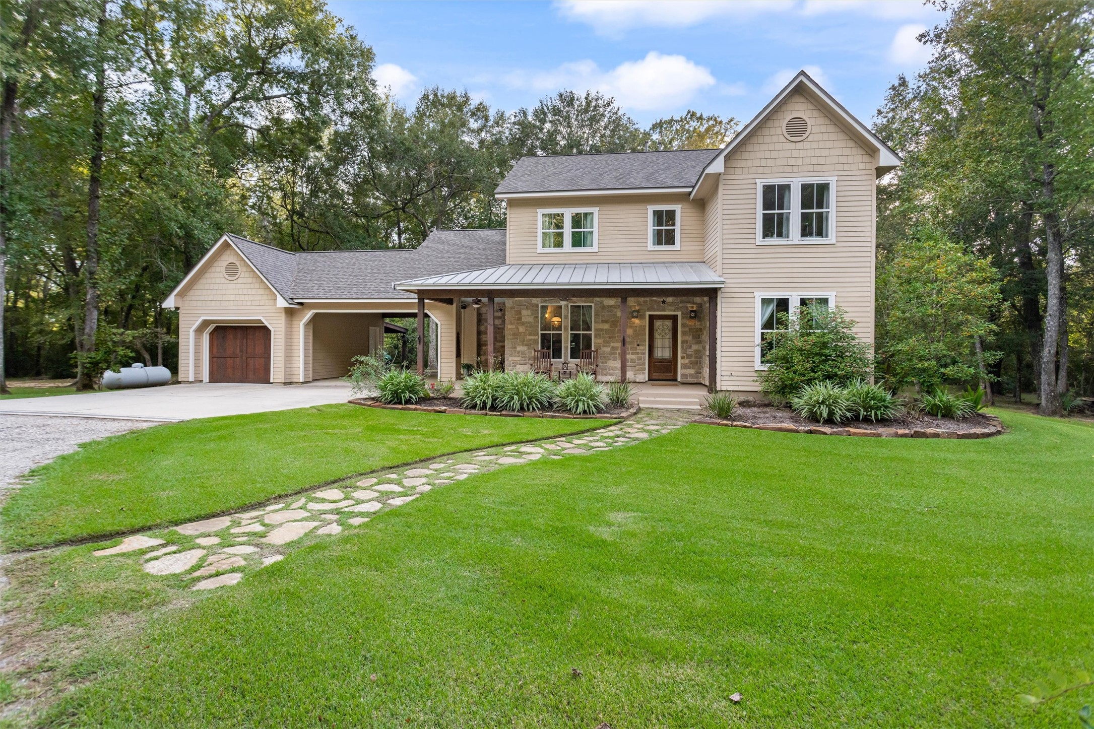 Classic two-story with stone accents and a manicured lawn Classic two-story with stone accents and a manicured lawn