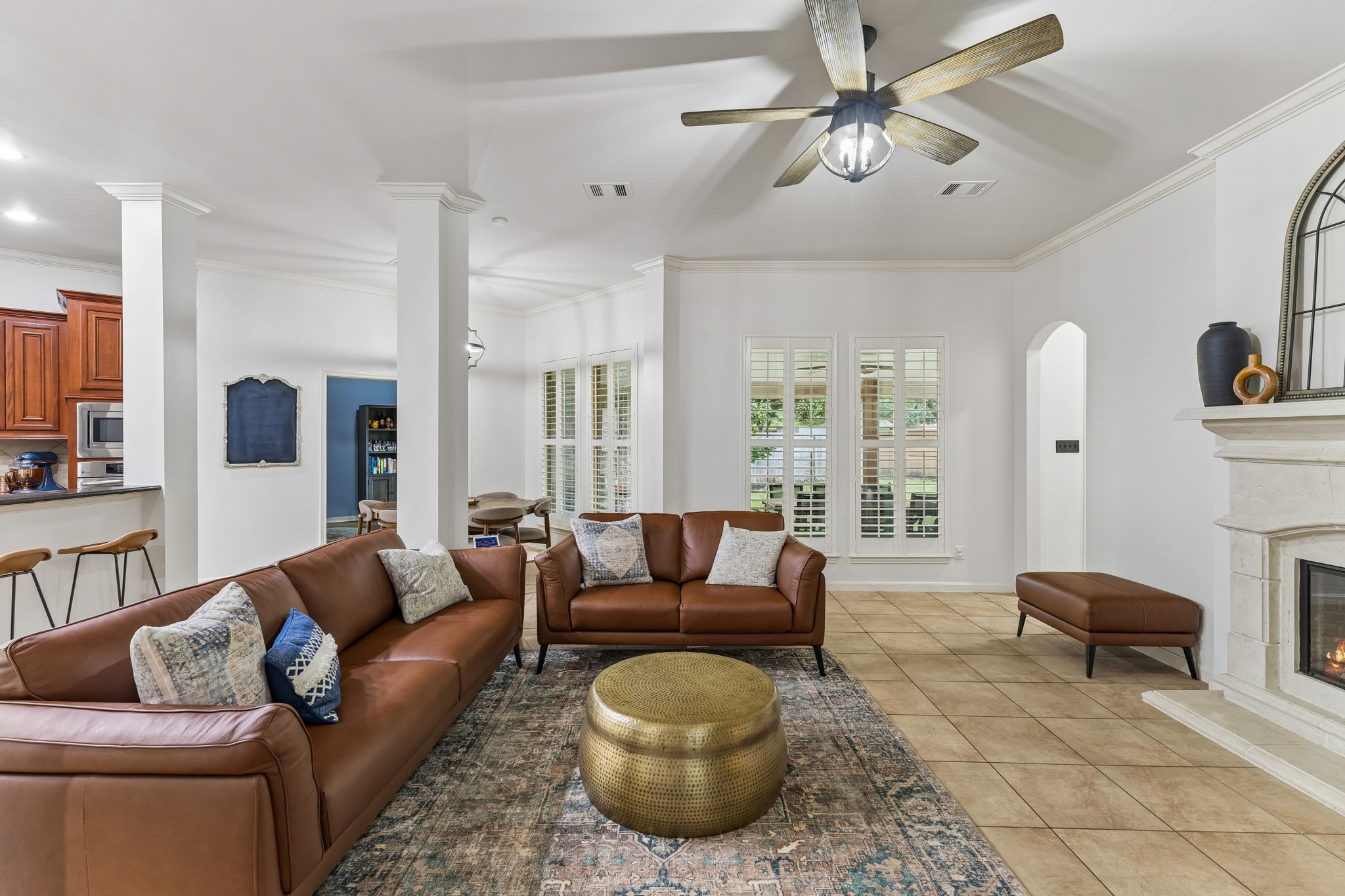 Additional living room view showcasing multiple windows, ceiling fan, and plenty of room for entertaining.