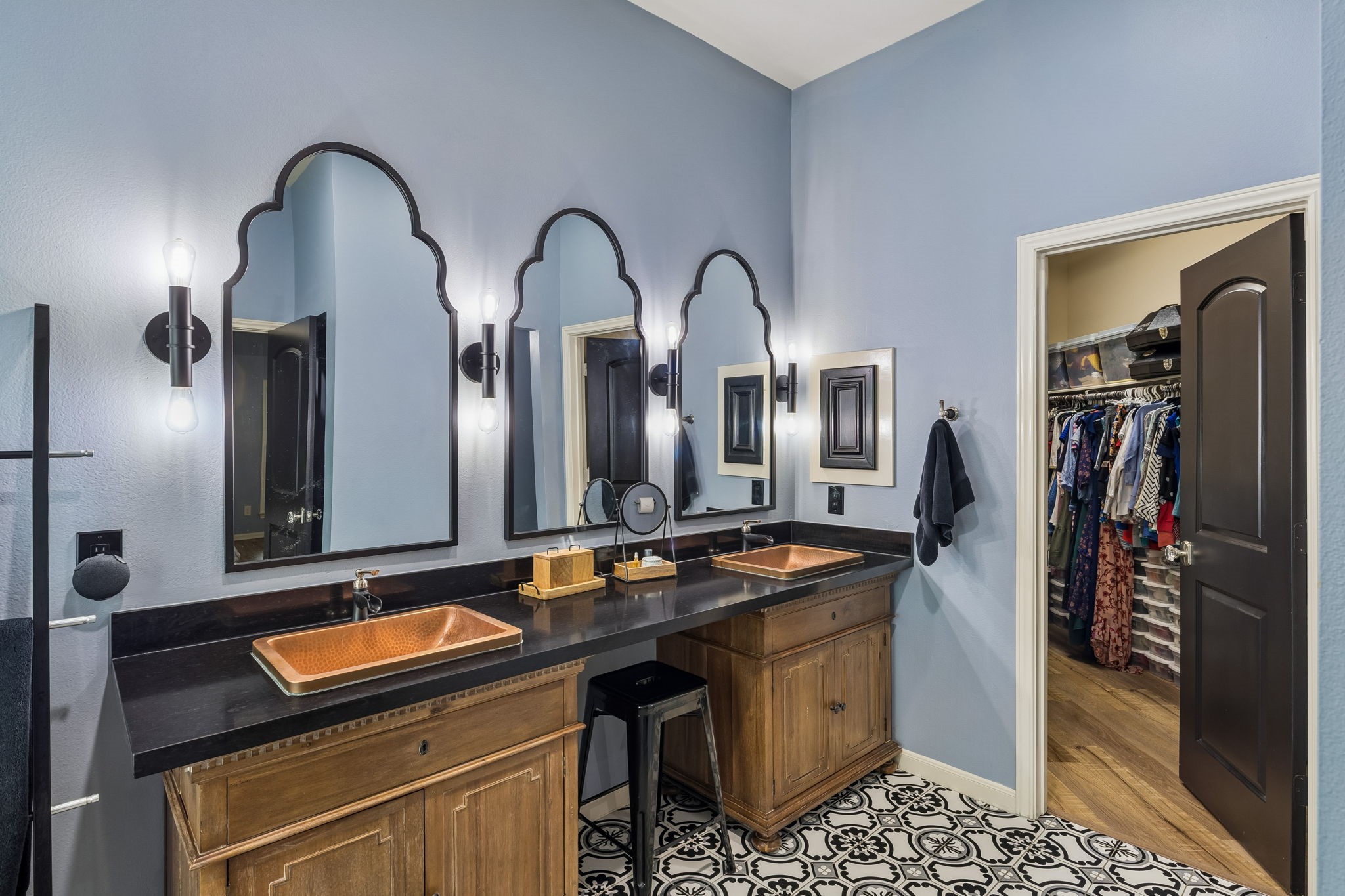 Dual vanities with ample cabinetry, large mirrors, and generous counter space.