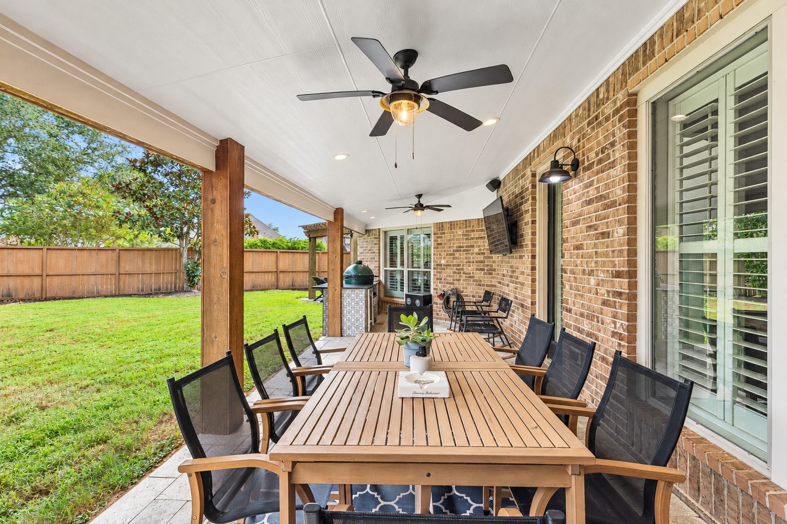 Covered outdoor living area overlooking the backyard, ideal for relaxing or entertaining. Covered outdoor living area overlooking the backyard, ideal for relaxing or entertaining.