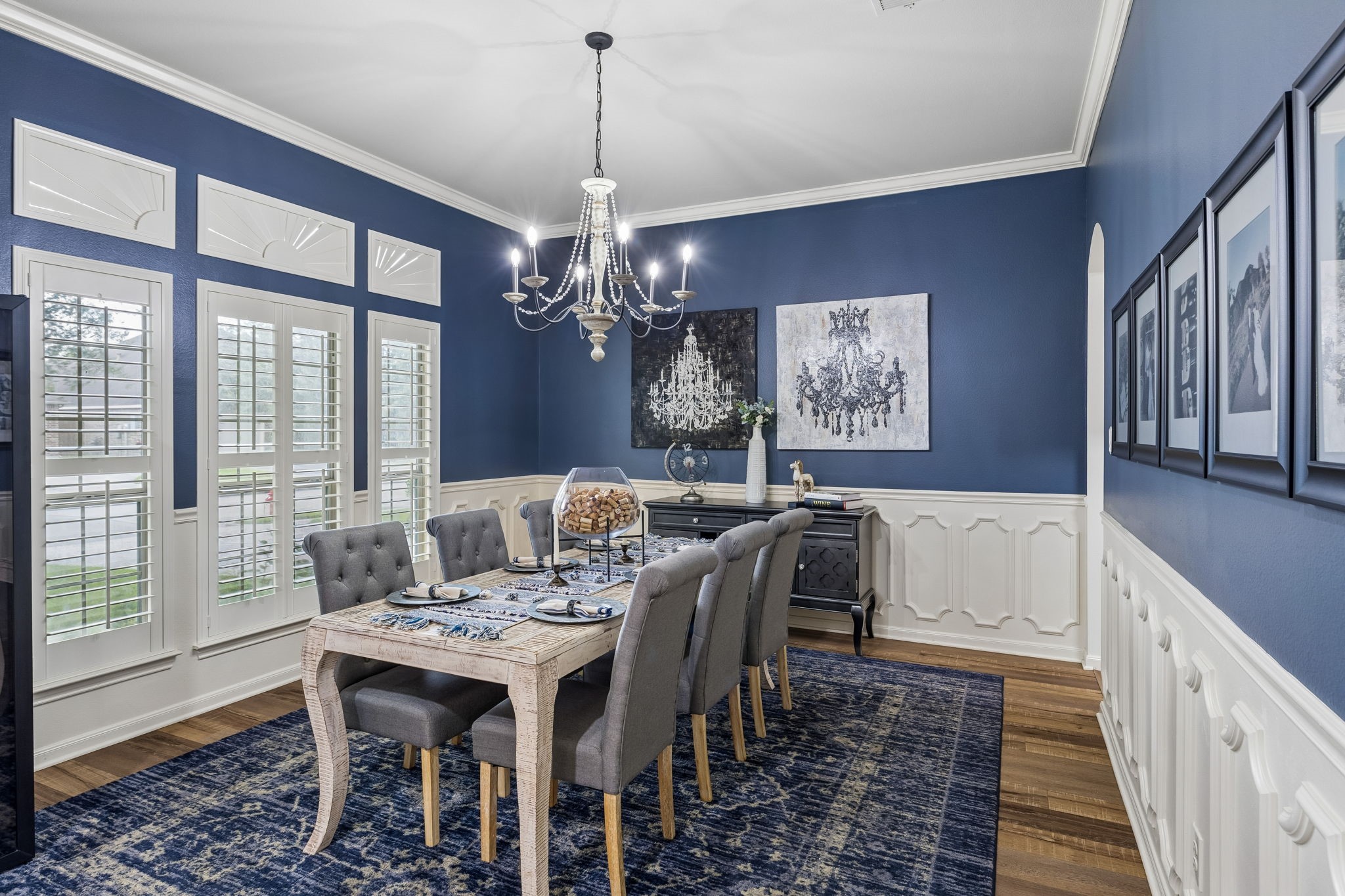 Formal dining area with rich wall color, large windows, and plenty of space for entertaining.