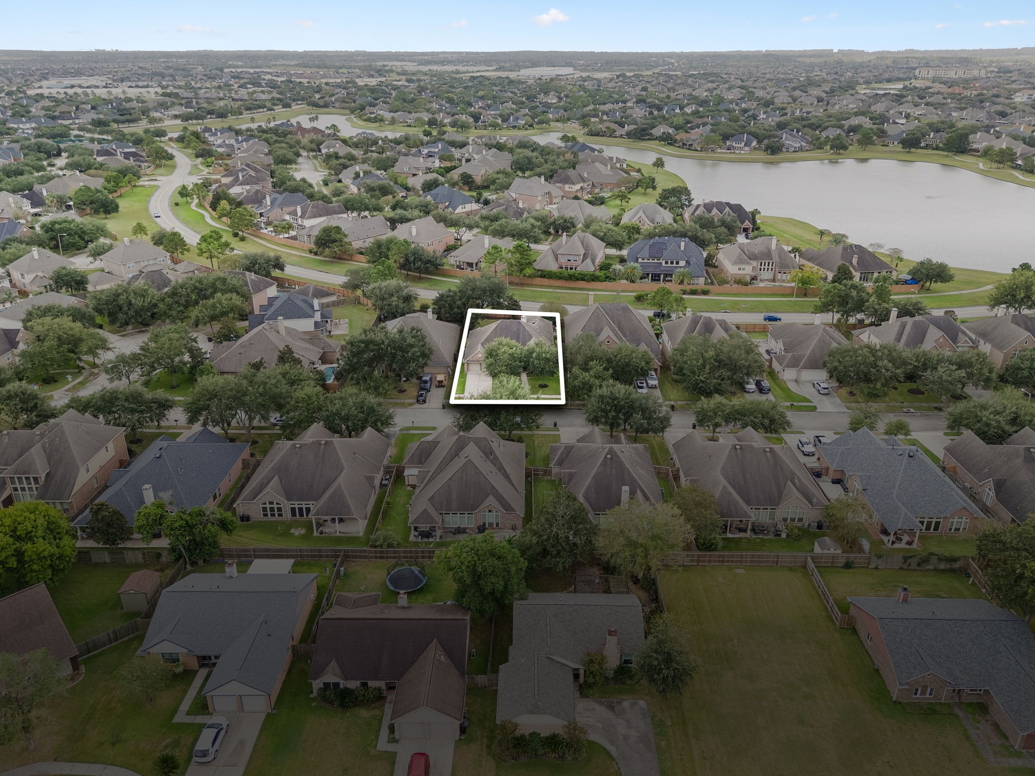 Wide aerial view showcasing the surrounding community and nearby residential streets.