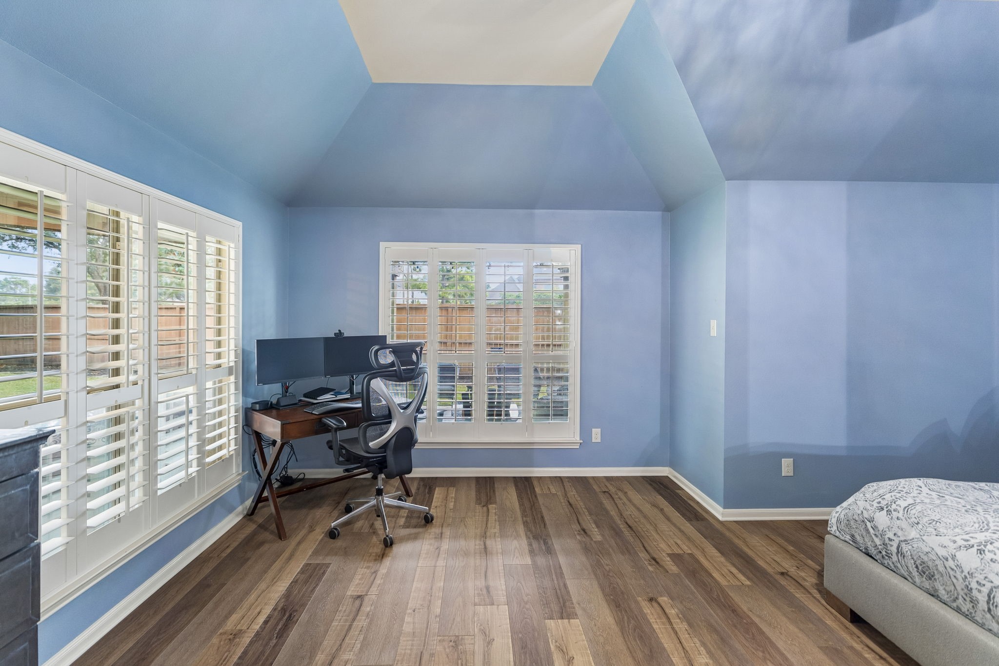 Additional view of the spacious room with built-ins, ceiling fan, and flexible use as a bedroom, office, or sitting area.