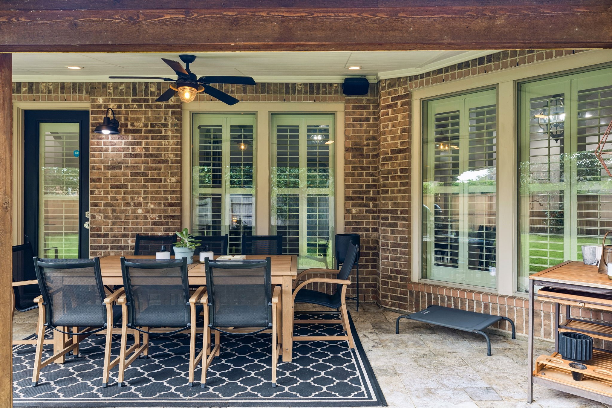 Additional patio view highlighting the covered seating area and convenient access to the home.