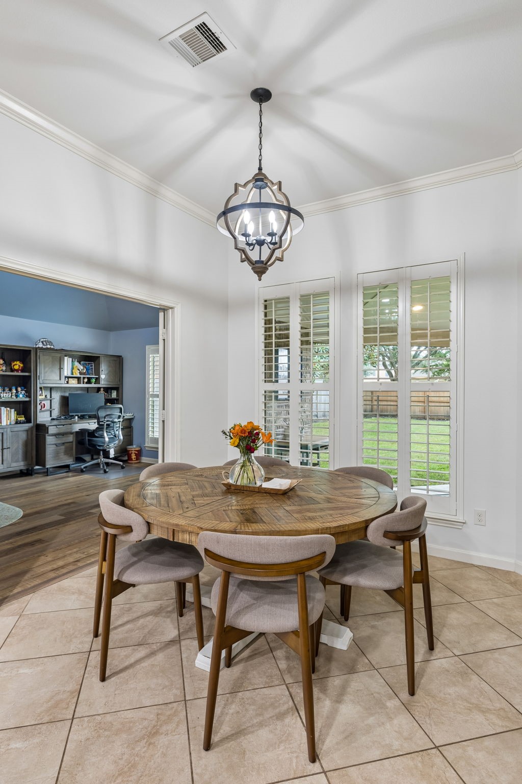 ight casual dining area with multiple windows, pendant lighting, and easy access to the kitchen.