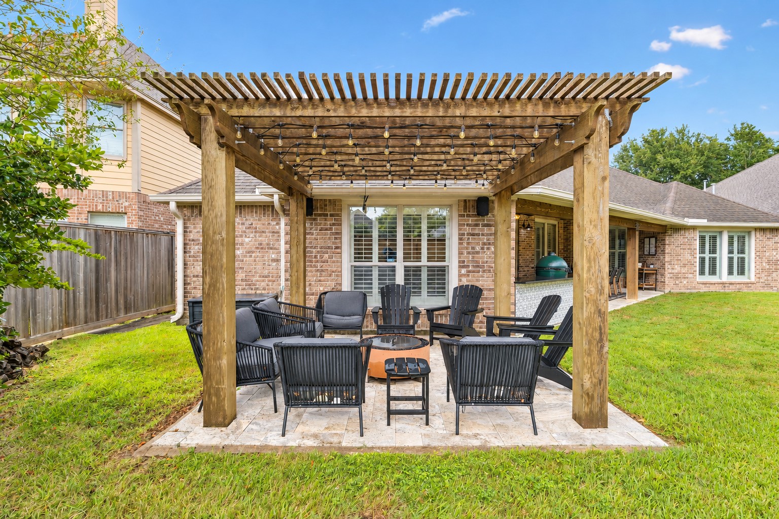 Rear patio and pergola area offering a comfortable outdoor space for dining and relaxation.