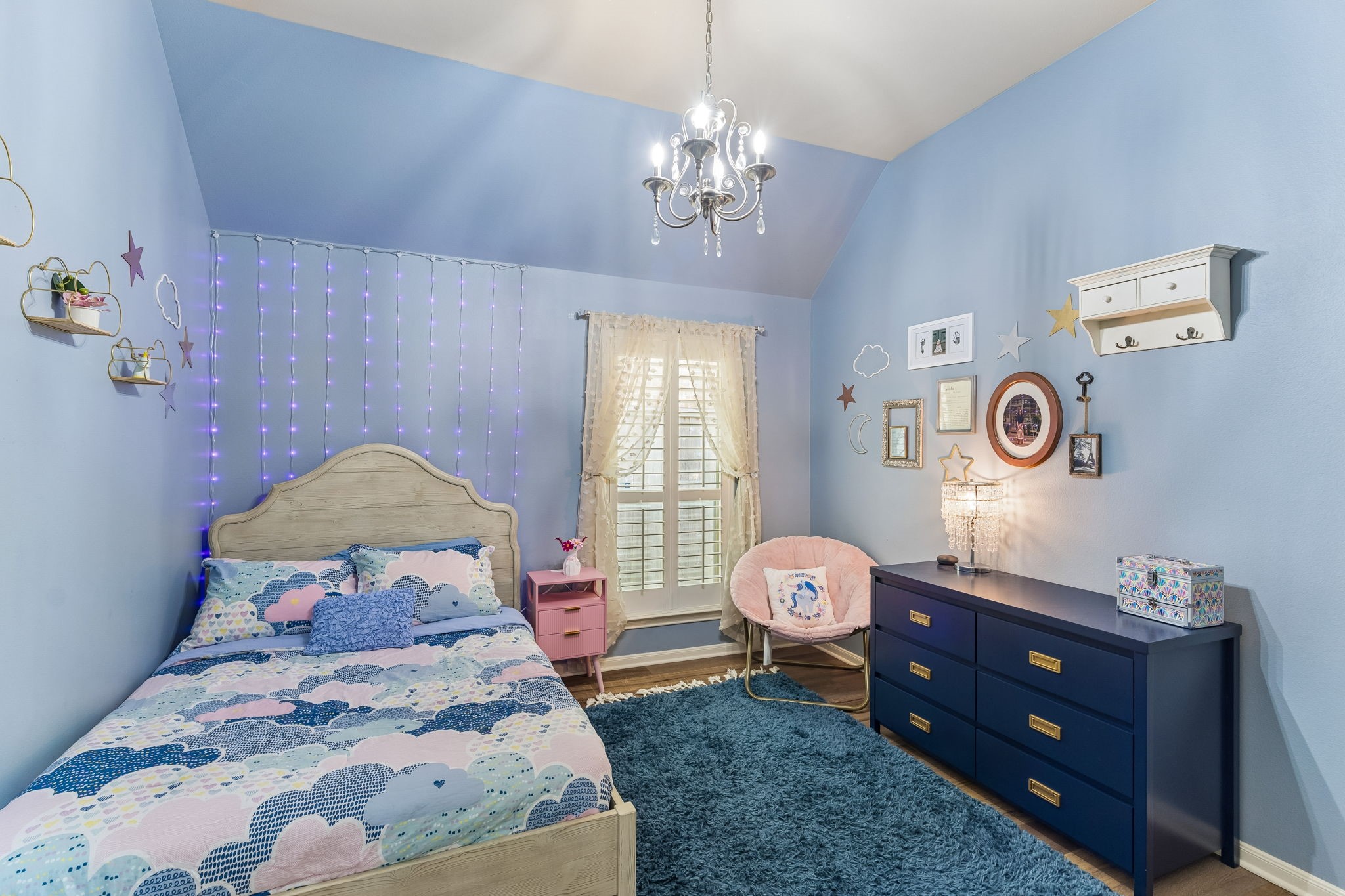 Bright bedroom with ceiling fan, natural light, and comfortable space for furnishings.