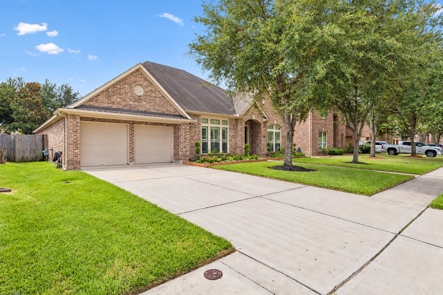 Additional front exterior view showcasing the driveway, garage, and well-maintained landscaping. Additional front exterior view showcasing the driveway, garage, and well-maintained landscaping.