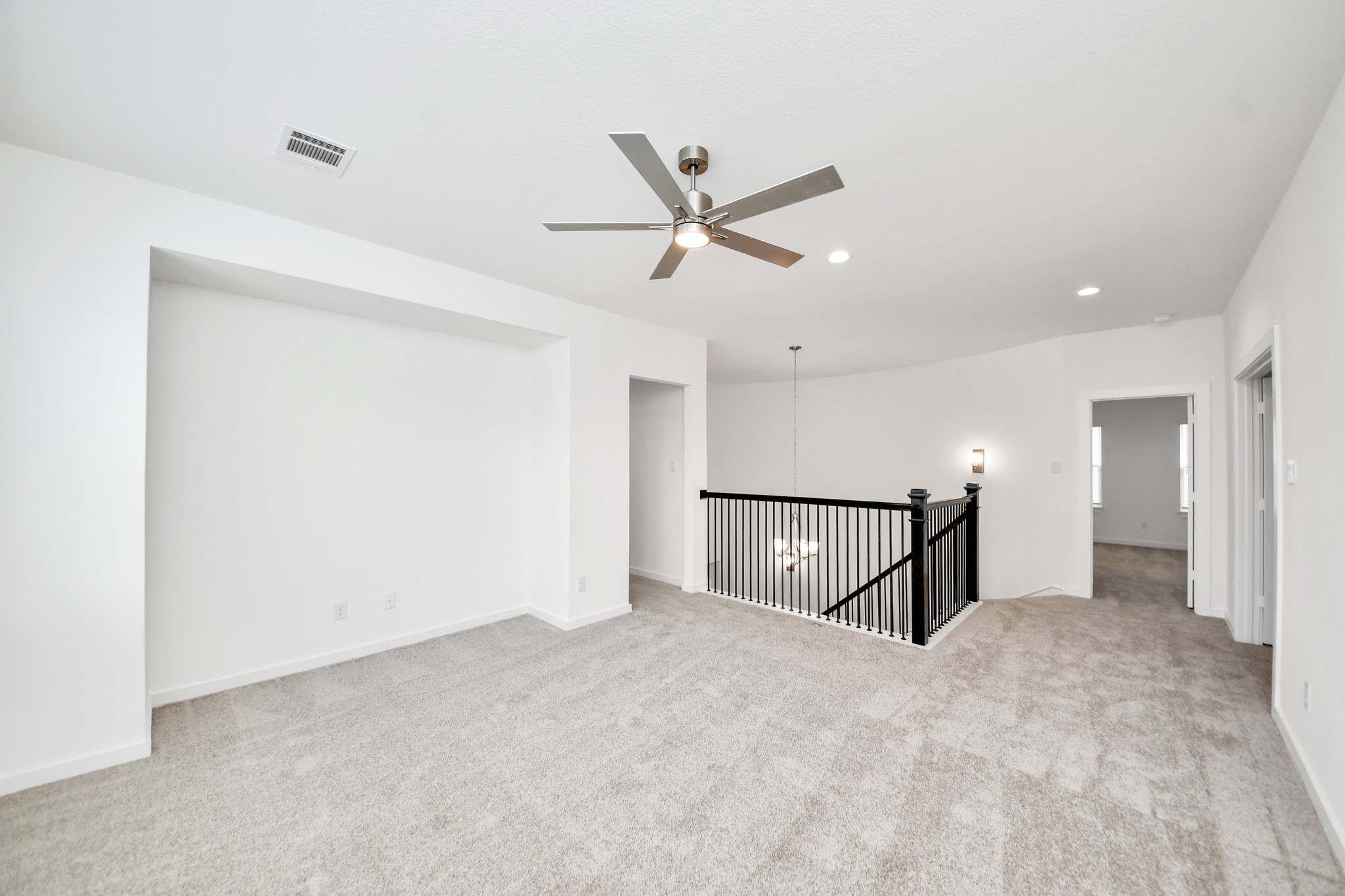 Ascend to relaxation in this fantastic game room! Ideal for both casual gatherings and adult gaming, it boasts plush carpet, lofty ceilings, custom paint, and ample windows for abundant natural light. Sample photo of completed home with similar floor plan. Actual colors and selections may vary.