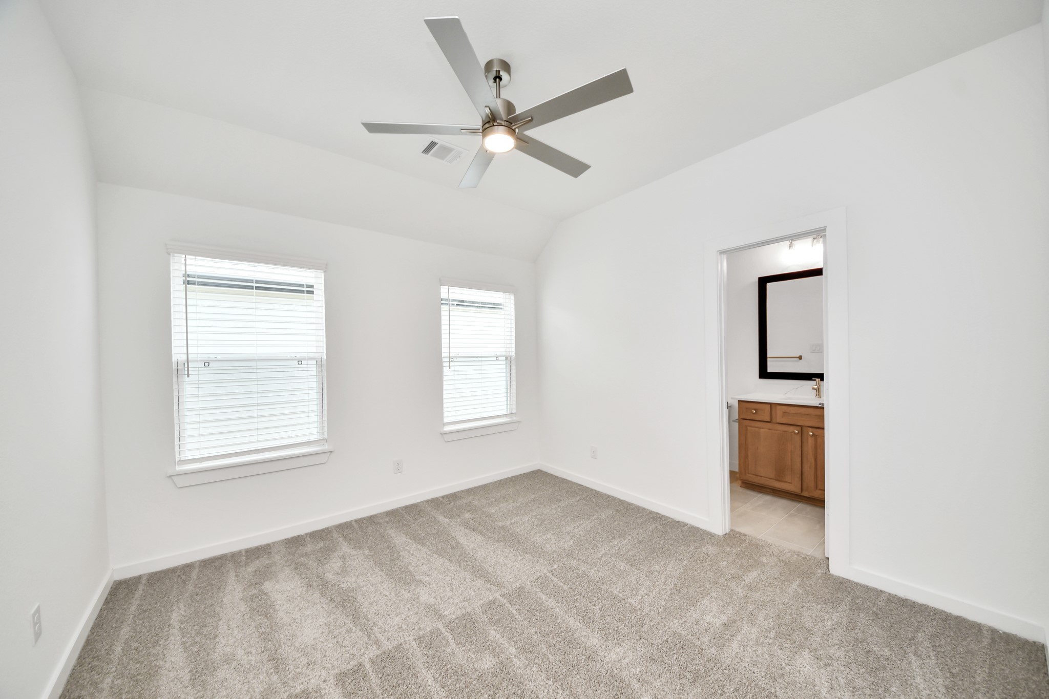 Generously sized secondary bedrooms featuring spacious closets, soft and inviting carpeting underfoot, large windows allowing plenty of natural light, and the added touch of privacy blinds for your personal retreat. Sample photo of completed home with similar floor plan. Actual colors and selections may vary.
