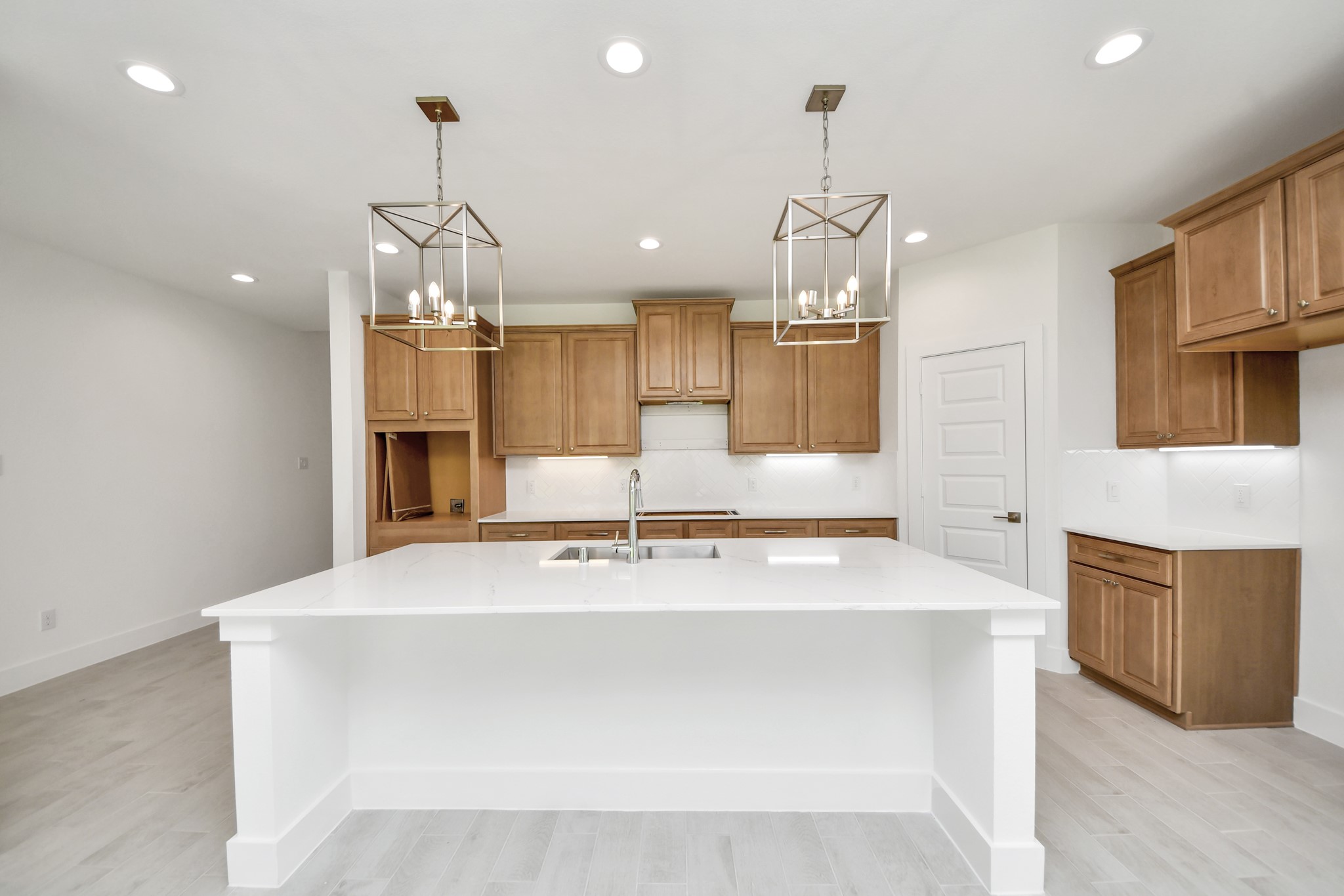 This kitchen is by far any chefs dream! This spacious kitchen features high ceilings, stained wood cabinets, granite countertop, SS appliances, modern tile backsplash, recessed lighting, extended counter space, granite kitchen island with double sink, and space for breakfast bar, and a walk-in pantry all overlooking your huge family room. Sample photo of completed home with similar floor plan. Actual colors and selections may vary. This kitchen is by far any chefs dream! This spacious kitchen features high ceilings, stained wood cabinets, granite countertop, SS appliances, modern tile backsplash, recessed lighting, extended counter space, granite kitchen island with double sink, and space for breakfast bar, and a walk-in pantry all overlooking your huge family room. Sample photo of completed home with similar floor plan. Actual colors and selections may vary.