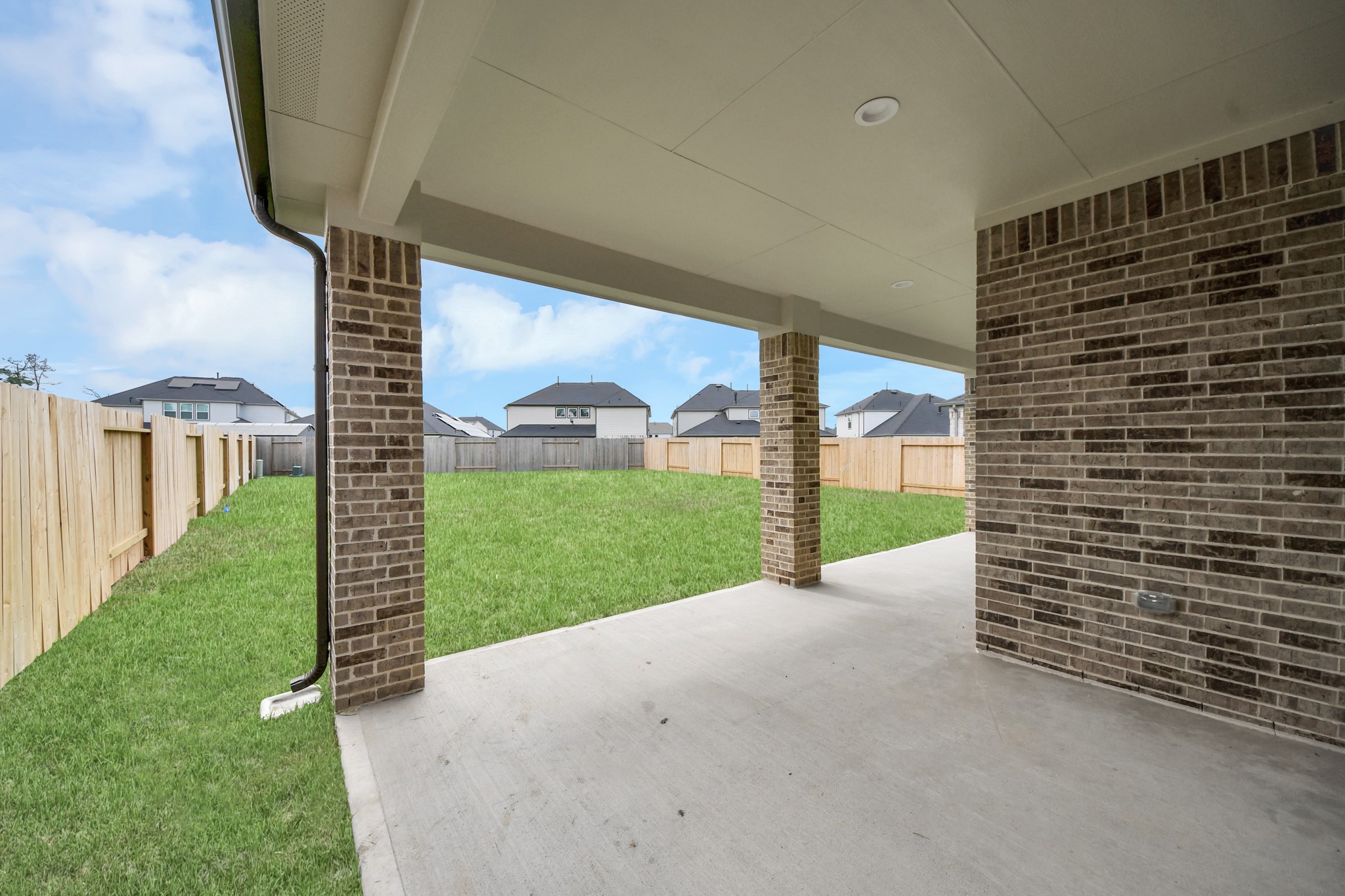 Experience outdoor living at its finest on this expansive covered patio, thoughtfully designed for BBQs and delightful outdoor dining. Sample photo of completed home with similar floor plan. Actual colors and selections may vary.