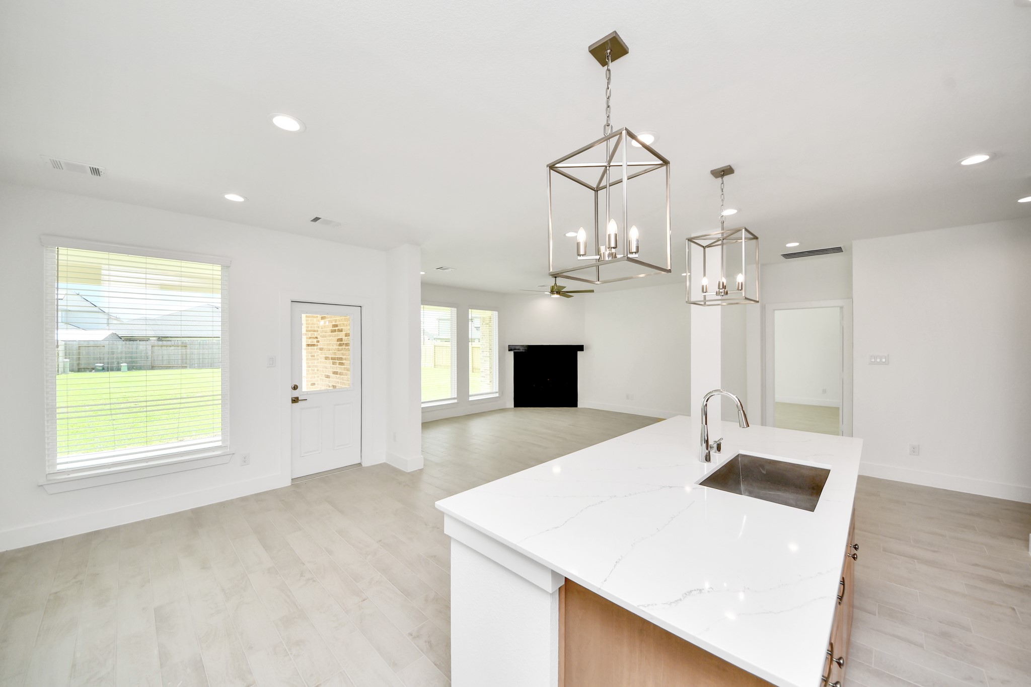 The open concept effortlessly connects the kitchen to the expansive family room, forming a perfect hub for gatherings. This seamless flow creates an inviting space where cooking and socializing come together harmoniously. Sample photo of completed home with similar floor plan. Actual colors and selections may vary.