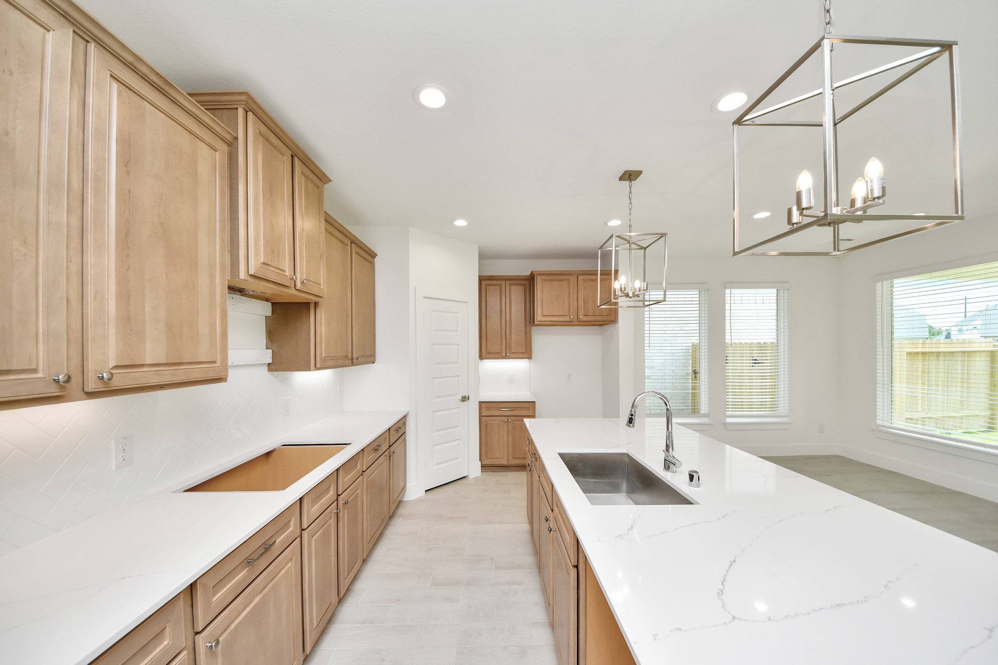 This generously spacious kitchen is a dream realized! With a massive granite island, high ceilings, soft close cabinets, granite countertops, stainless steel appliances, a sleek tile backsplash, recessed lighting, and an extended counter area, it offers both style and practicality. All this opens up to the expansive family room, creating a perfect hub for gatherings. Sample photo of completed home with similar floor plan. Actual colors and selections may vary. This generously spacious kitchen is a dream realized! With a massive granite island, high ceilings, soft close cabinets, granite countertops, stainless steel appliances, a sleek tile backsplash, recessed lighting, and an extended counter area, it offers both style and practicality. All this opens up to the expansive family room, creating a perfect hub for gatherings. Sample photo of completed home with similar floor plan. Actual colors and selections may vary.