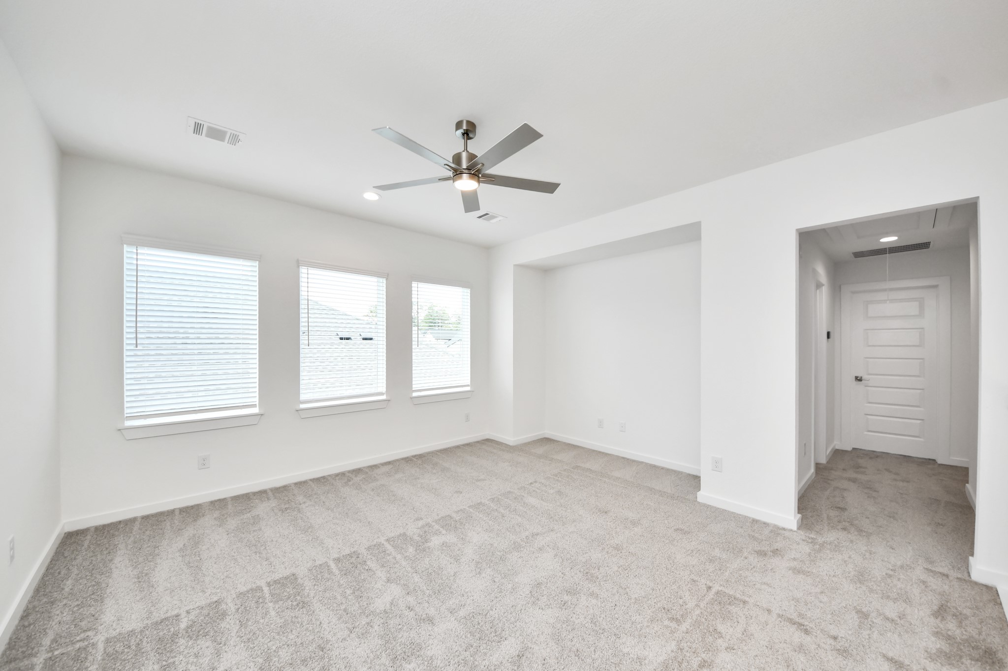 Come upstairs and enjoy a day of leisure in this fabulous game room! This is the perfect hangout spot or adult game room! Features plush carpet, high ceilings, custom paint and windows for plenty of natural light. Sample photo of completed home with similar floor plan. Actual colors and selections may vary.