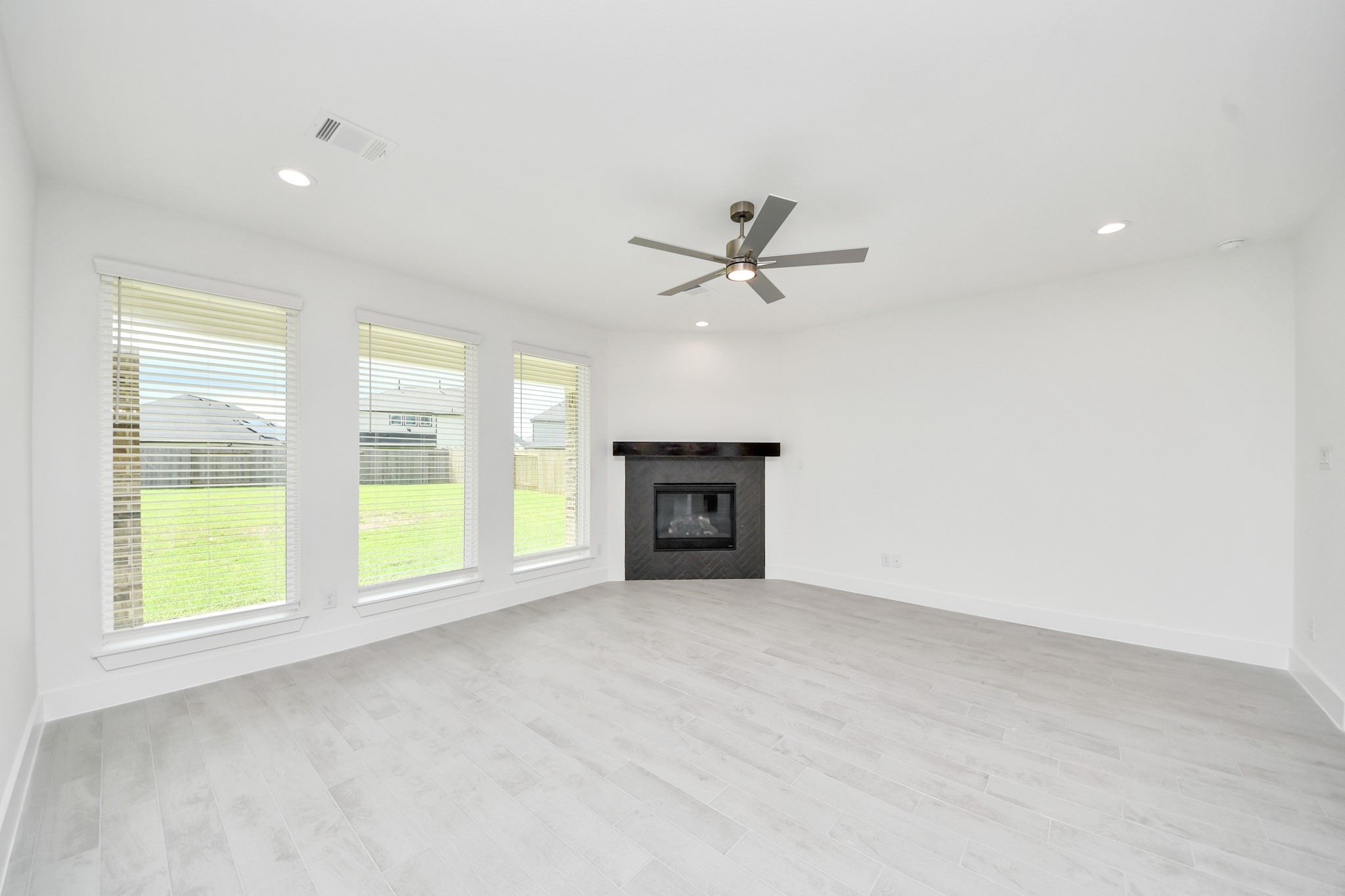 Gather the family and guests together in your lovely living room! Featuring soaring high ceilings, recessed lighting, ceiling fan, custom paint, gorgeous floors, and large windows that provide plenty of natural lighting throughout the day. Sample photo of completed home with similar floor plan. Actual colors and selections may vary.