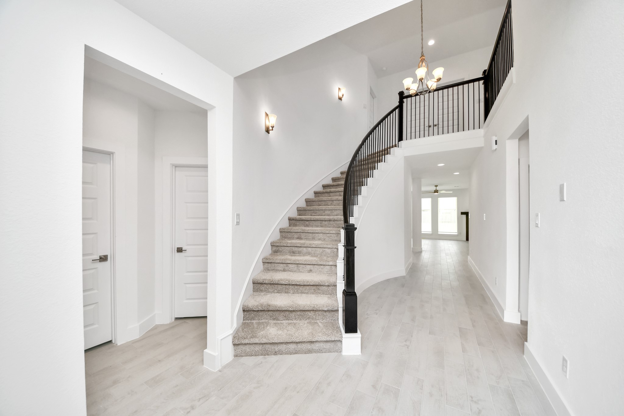 As you step into the threshold of this luxurious home, you'll soon be welcomed by an elegant glass door (to be installed). Inside, soaring ceilings amplify the spaciousness, while the refined wood-look tile flooring and oversized baseboards exude sophistication and charm. Sample photo of completed home with similar floor plan. Actual colors and selections may vary. As you step into the threshold of this luxurious home, you'll soon be welcomed by an elegant glass door (to be installed). Inside, soaring ceilings amplify the spaciousness, while the refined wood-look tile flooring and oversized baseboards exude sophistication and charm. Sample photo of completed home with similar floor plan. Actual colors and selections may vary.