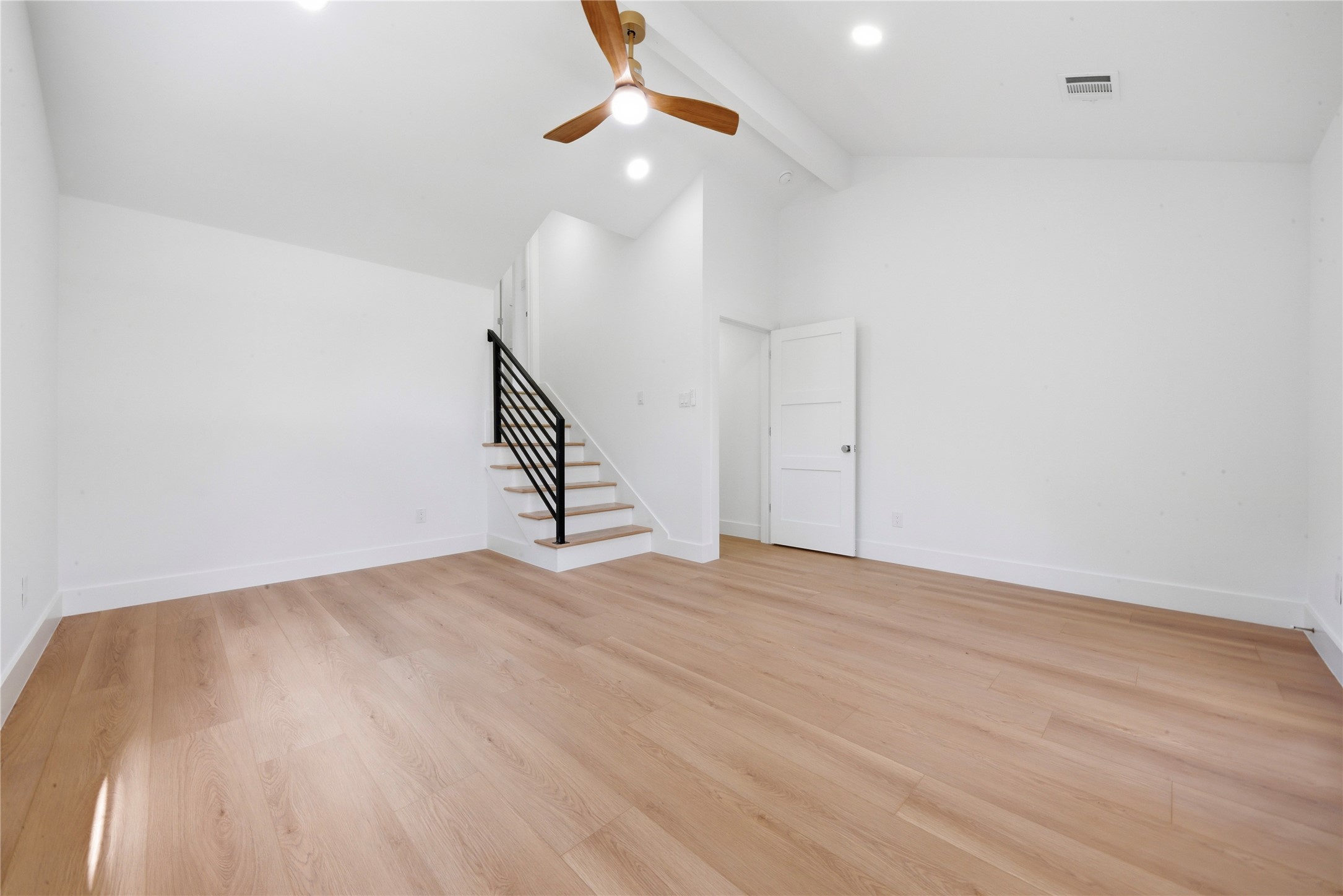 Soaring vaulted second primary suite with private interior staircase leading up to the dedicated fourth-floor ensuite bath and walk-in closet. Wide-plank floors and abundant natural light throughout.