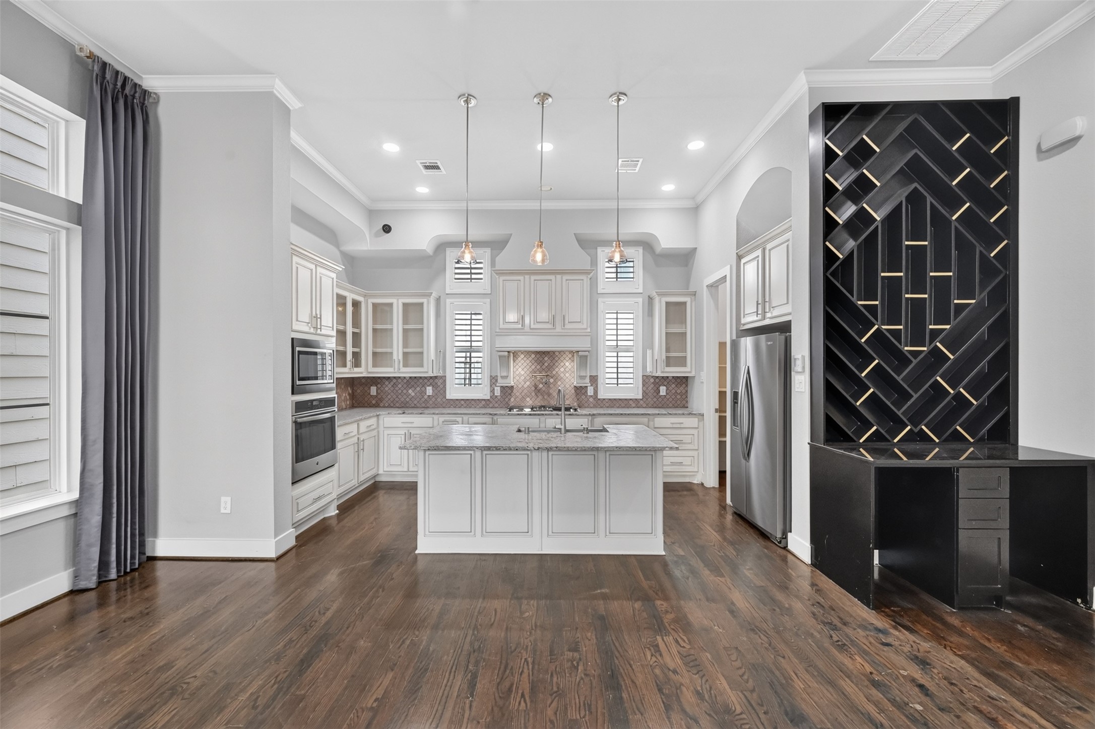 High ceilings, recess lighting, window treatments with plantation shutters