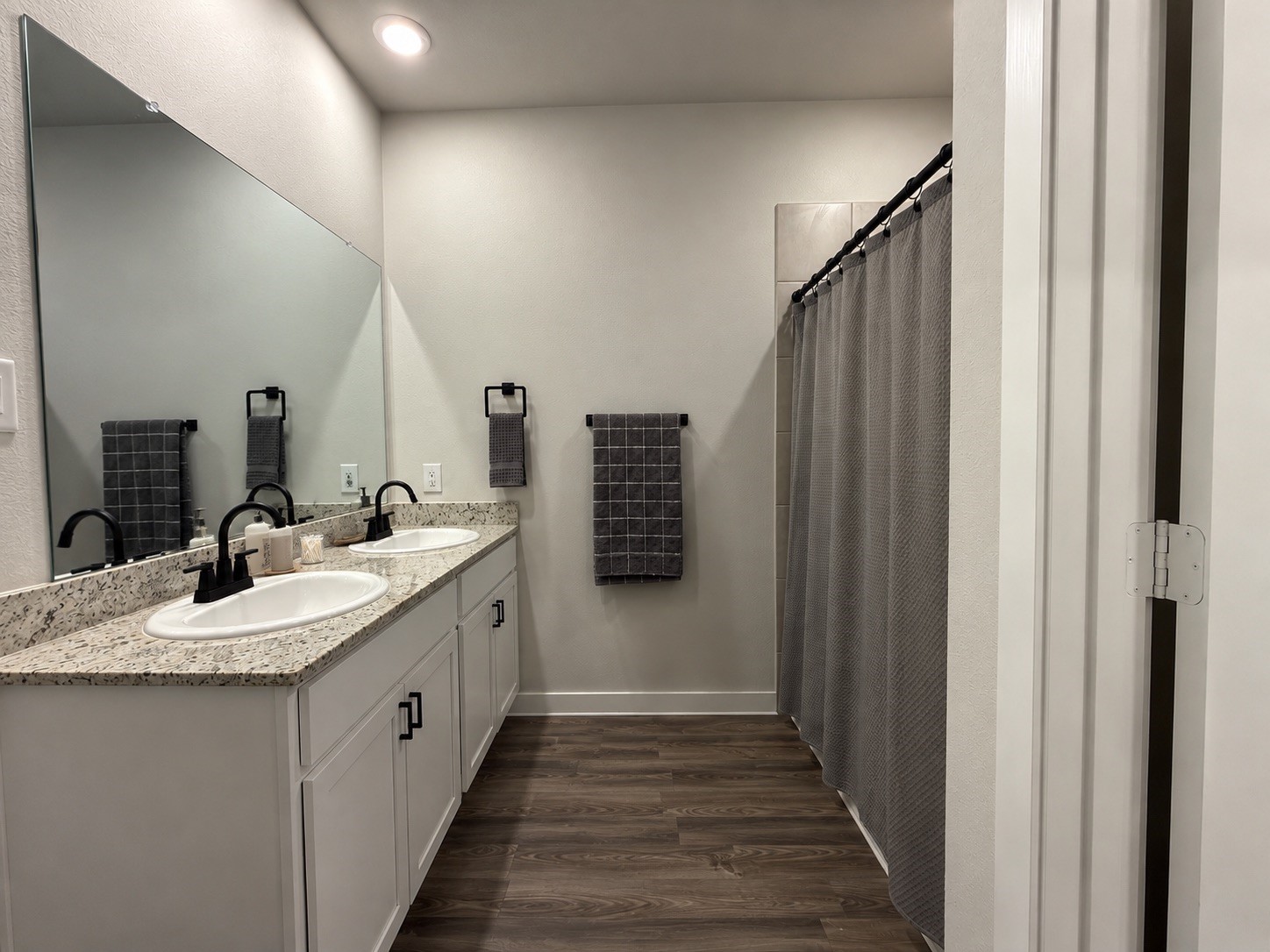 Primary Bathroom with Double Sinks and Shower/Tub Combo Primary Bathroom with Double Sinks and Shower/Tub Combo