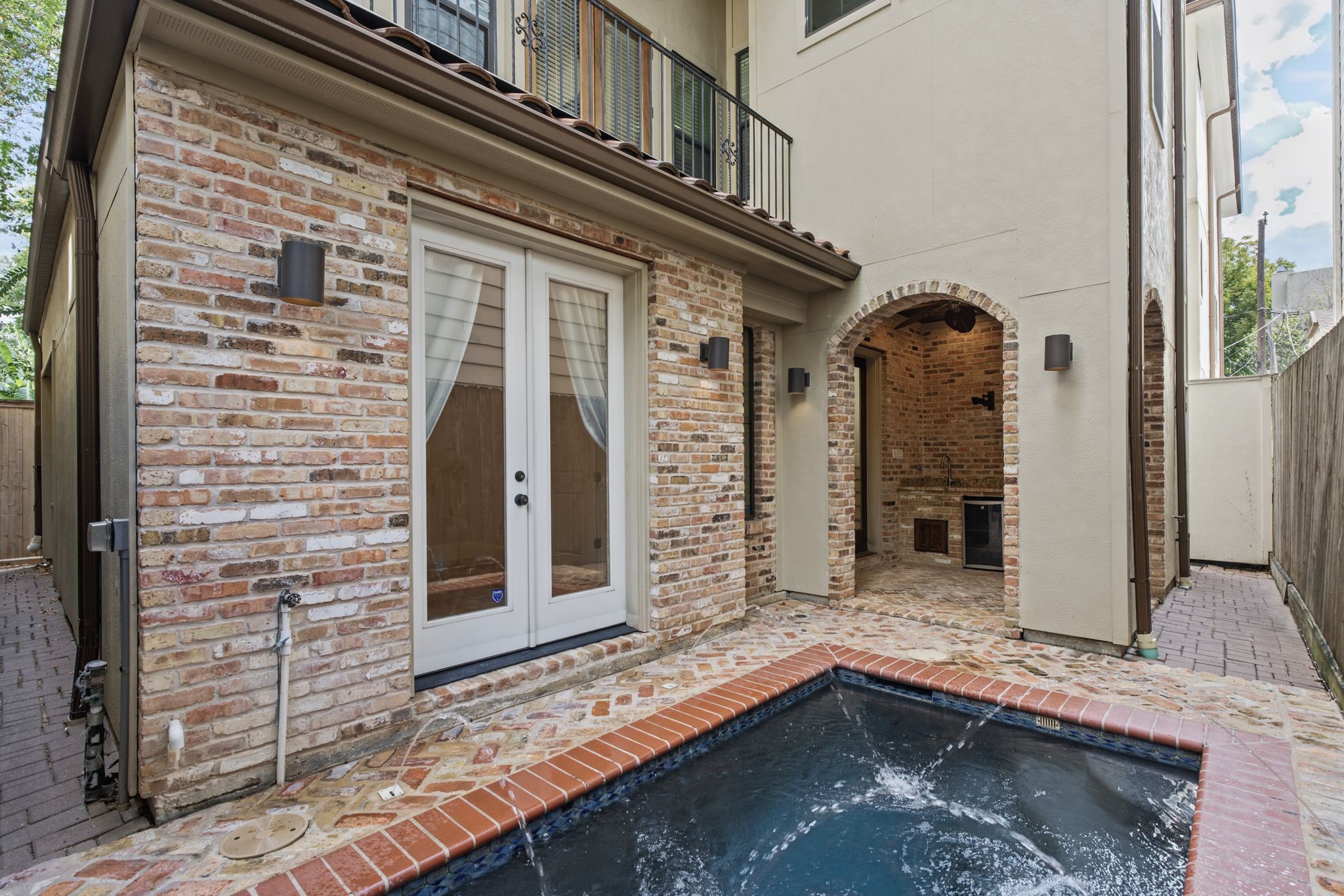 Welcome Home | Private Courtyard & Summer Kitchen  Welcome to 4122 Floyd, where the energy of the city gives way to the tranquility of your own Mediterranean-inspired retreat. A private plunge pool with a soothing water feature and inviting summer kitchen set the stage for leisurely afternoons, intimate gatherings, and evenings under the stars.