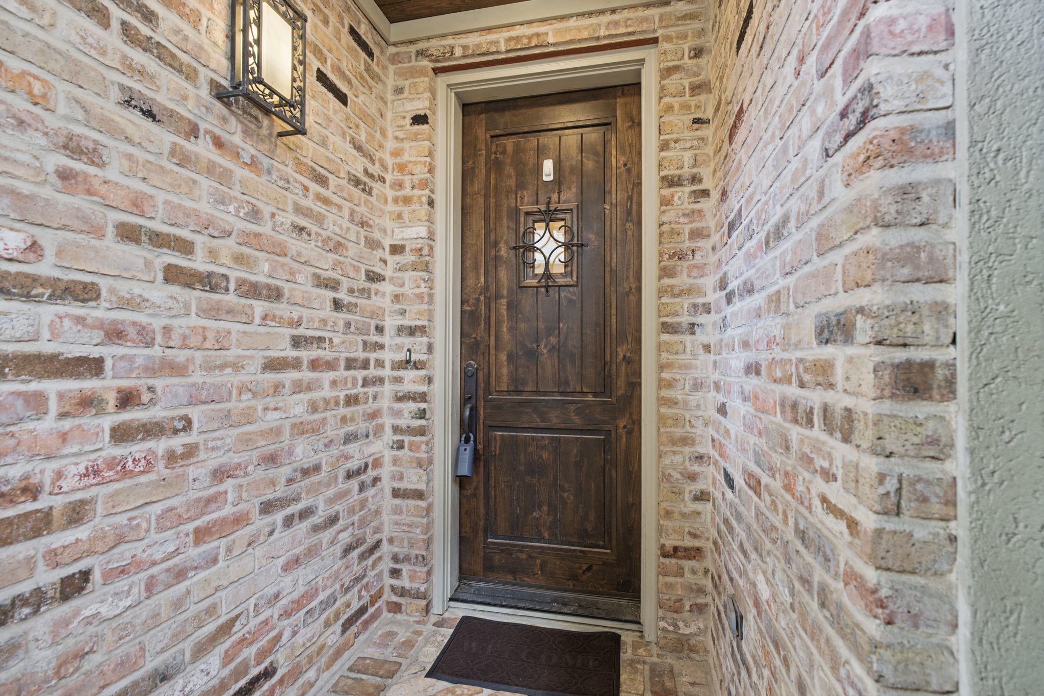 Front Entry  Beyond the handsome wood front door, a warm welcome awaits. Step inside and discover a home where Mediterranean charm, inviting spaces, and thoughtful details make you feel immediately at home.