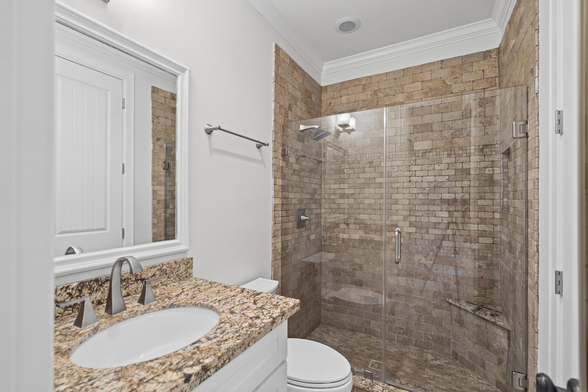 Guest Bathroom [5 x 9]  First Floor. An elegantly appointed ensuite featuring a glass-enclosed walk-in shower, offering guests the comfort and privacy of their own dedicated accommodations.