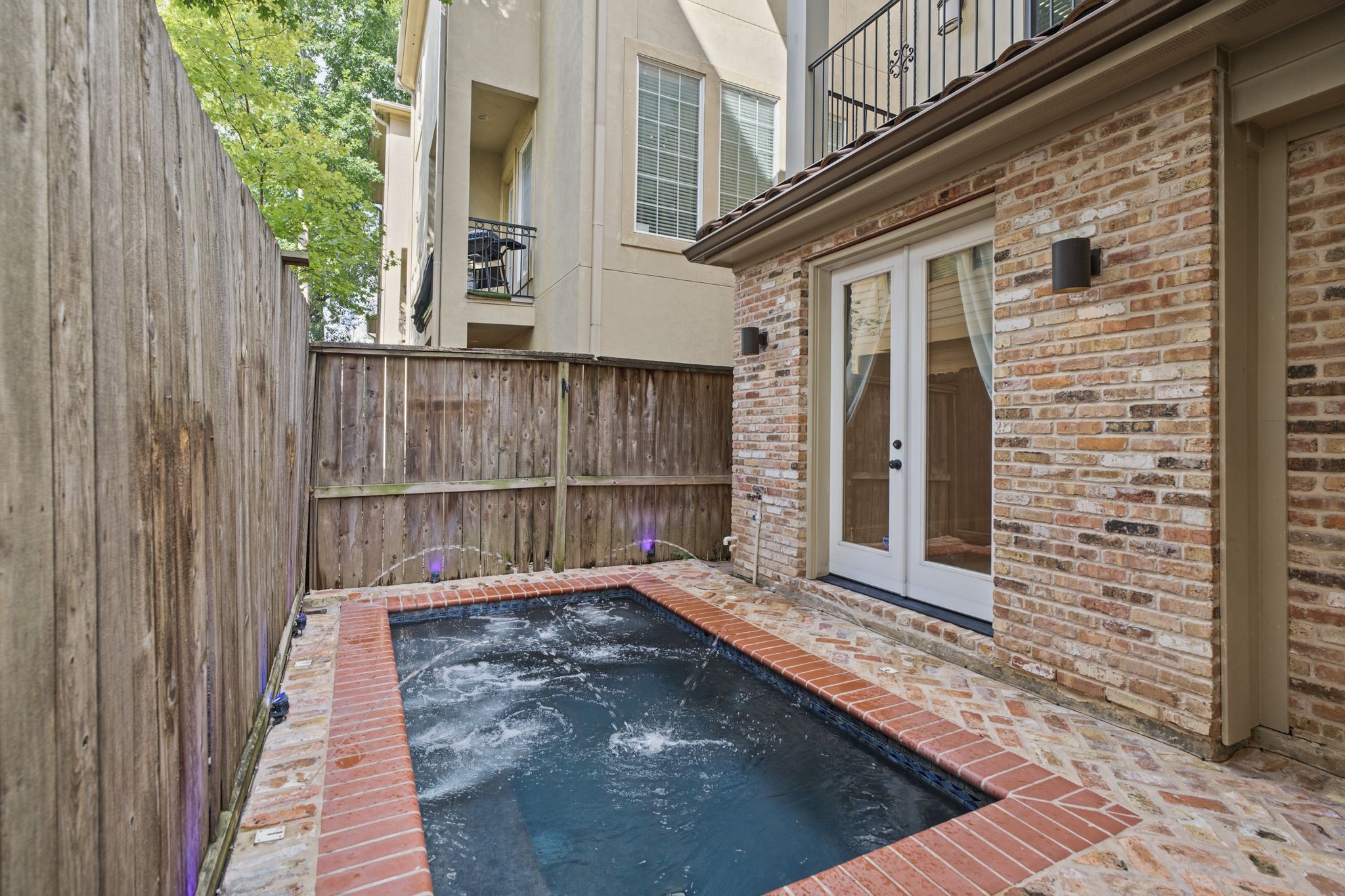 Private Plunge Pool | Courtyard  A rare luxury in the heart of Rice Military, this secluded plunge pool transforms the courtyard into a personal oasis, offering a refreshing escape from the citys vibrant pace without ever leaving home.