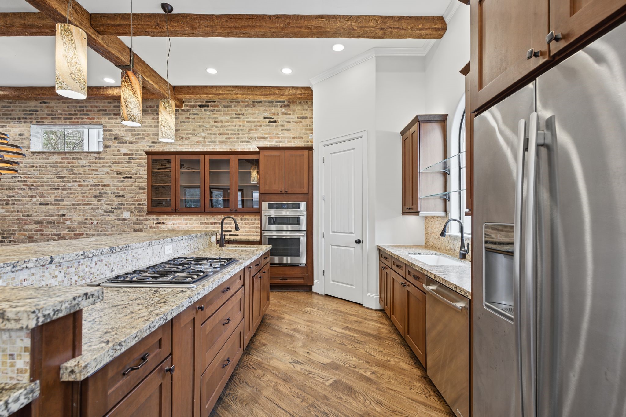Kitchen [24 x 12]  Second Floor. Layered cabinet lighting, a dedicated wine and beverage refrigerator, and walk-in pantry complete the experience.