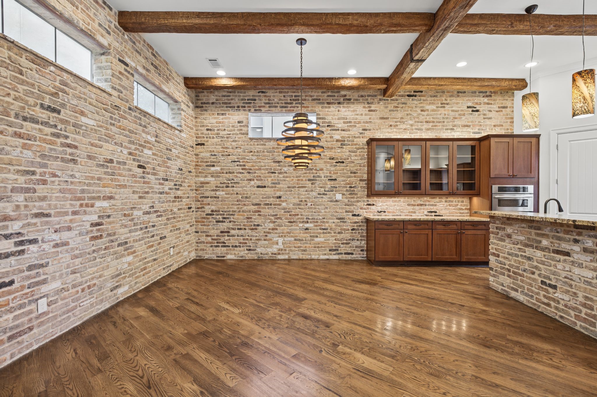 Dining Area [8 x 16]  Second Floor. Elegant transom windows introduce soft natural light into this inviting dining space, where an open connection to the kitchen creates an effortless setting for intimate dinners and evenings shared with friends.