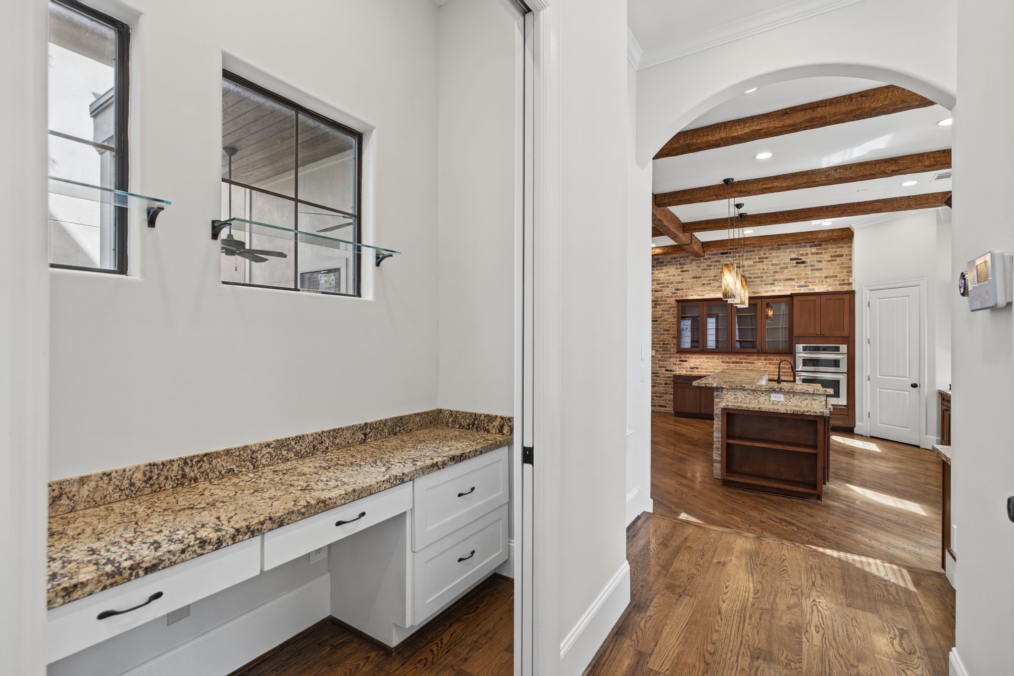 Workstation  Second Floor. Framed by two windows that welcome natural light, this thoughtfully integrated built-in desk creates an inviting space for working from home, managing daily affairs, or finding a quiet moment of productivity.