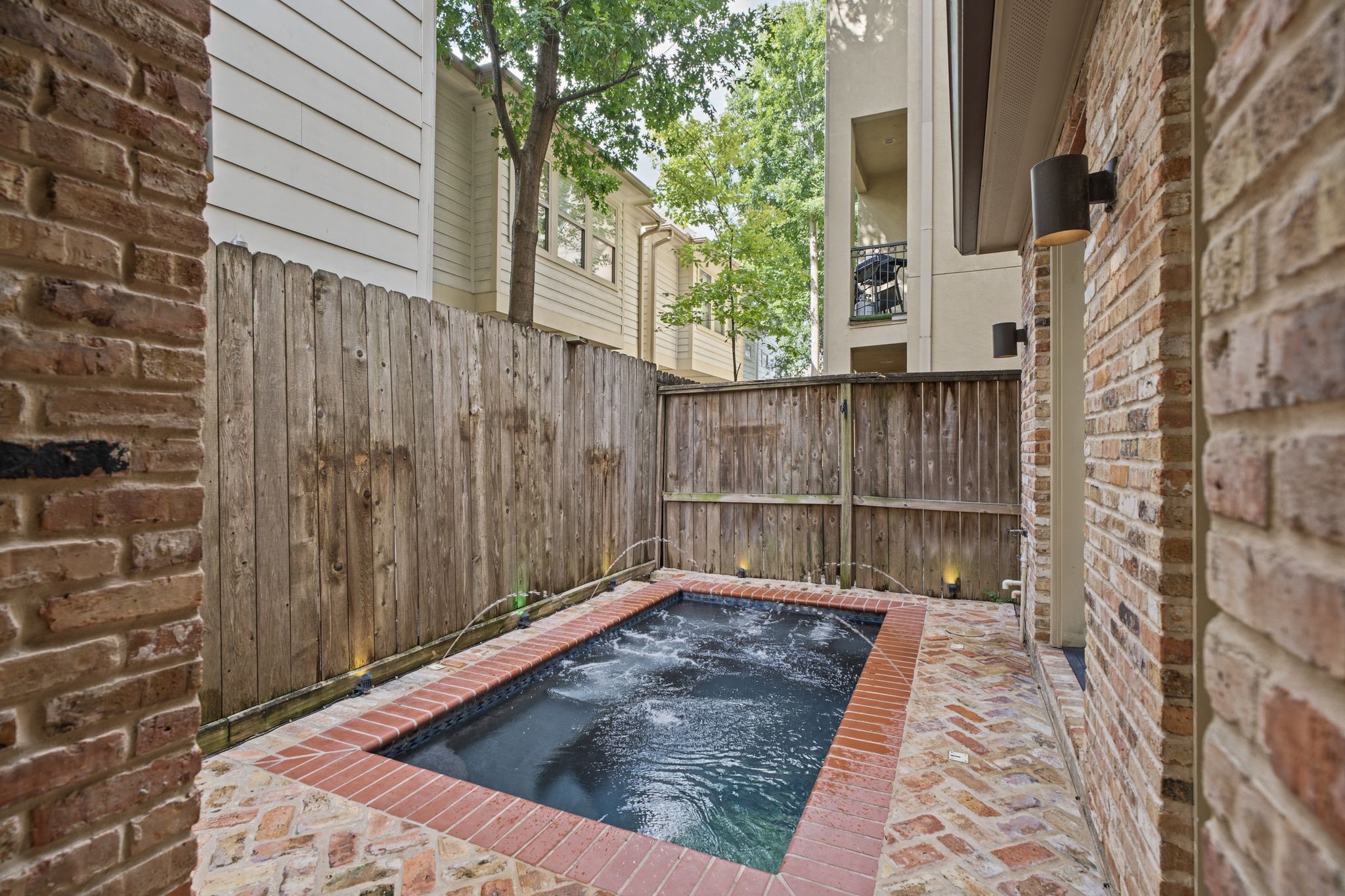 Private Plunge Pool | Water Feature  The gentle sound of flowing water sets a tranquil mood, while integrated jets and ambient poolside lighting create an inviting atmosphere for unwinding beneath the open sky.