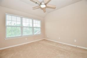 Another secondary bedroom with windows overlooking the front of the house