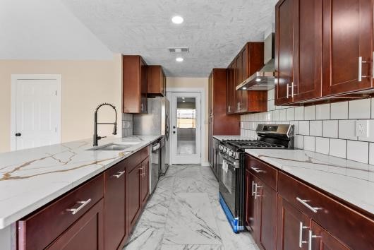 Modern kitchen with dark wood cabinets, quartz countertops, and all new stainless steel appliances, makes cooking a dream. Modern kitchen with dark wood cabinets, quartz countertops, and all new stainless steel appliances, makes cooking a dream.