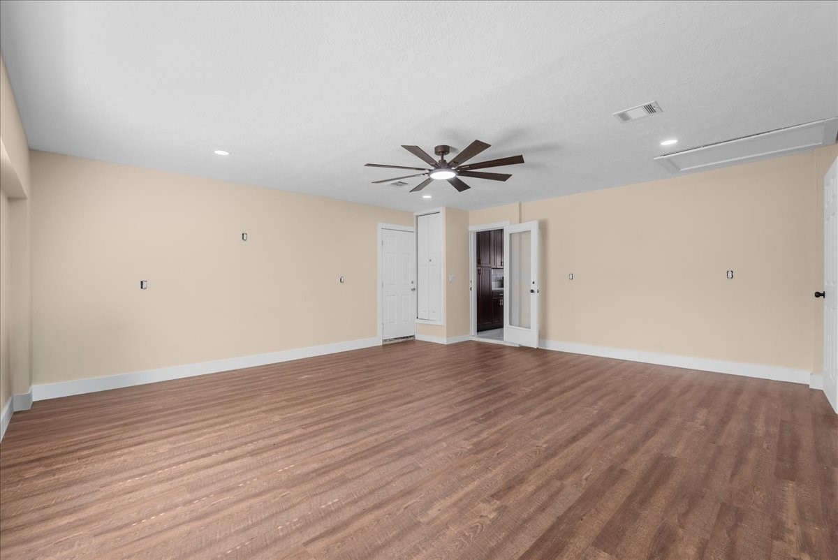 Flex Room with wood like flooring , and rear door going to back yard and glass door to kitchen