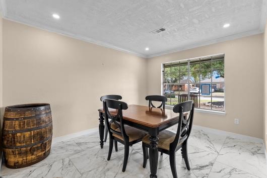 Formal dining area features updated flooring, recessed lighting and large windows , allowing an abundance of natural light..