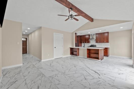 open concept living area also views down foyer to front door.