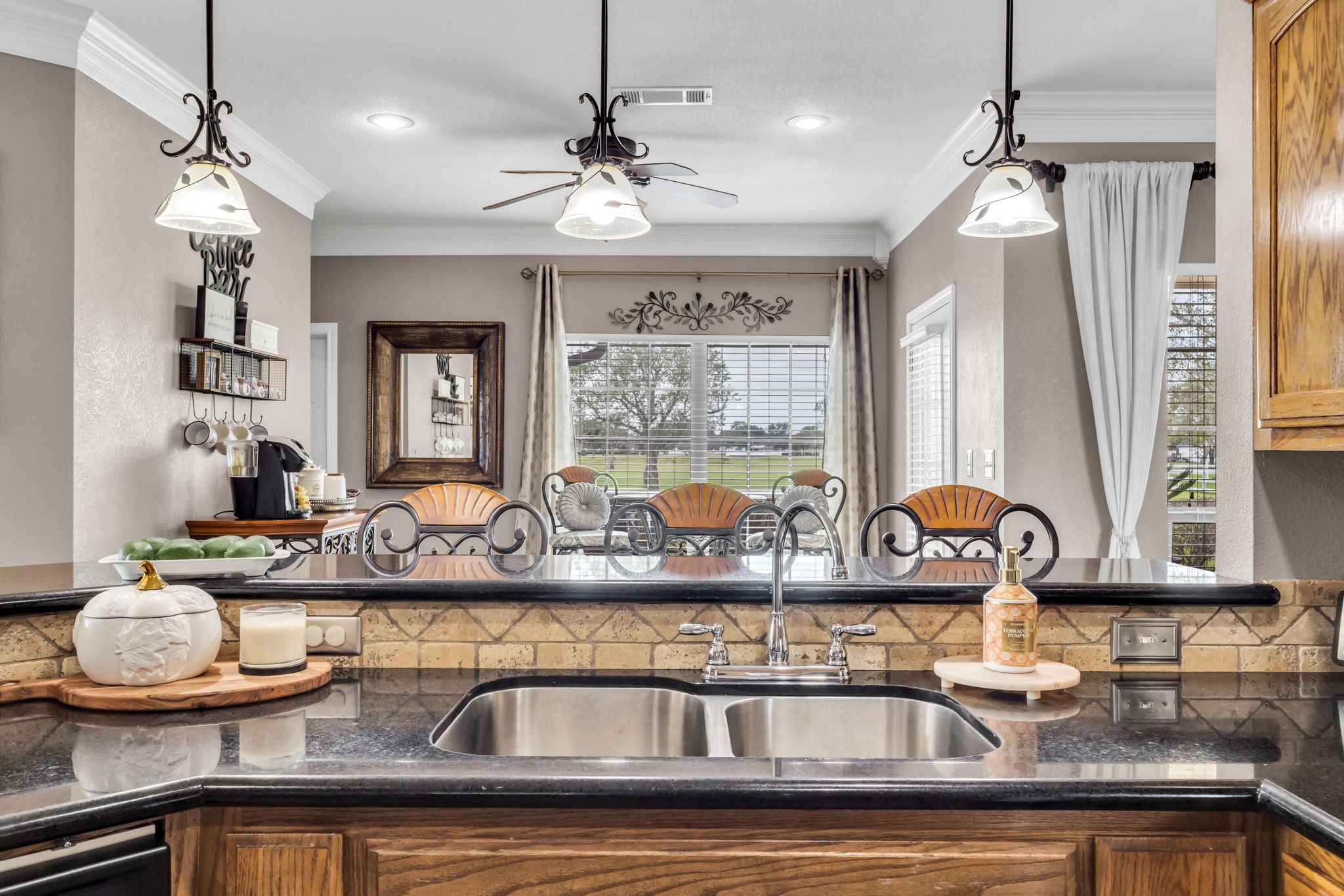 Bright breakfast area with a dedicated space currently used as a coffee bar, offering a cozy spot to enjoy your morning coffee. Large windows bring in natural light and provide views of the outdoors.