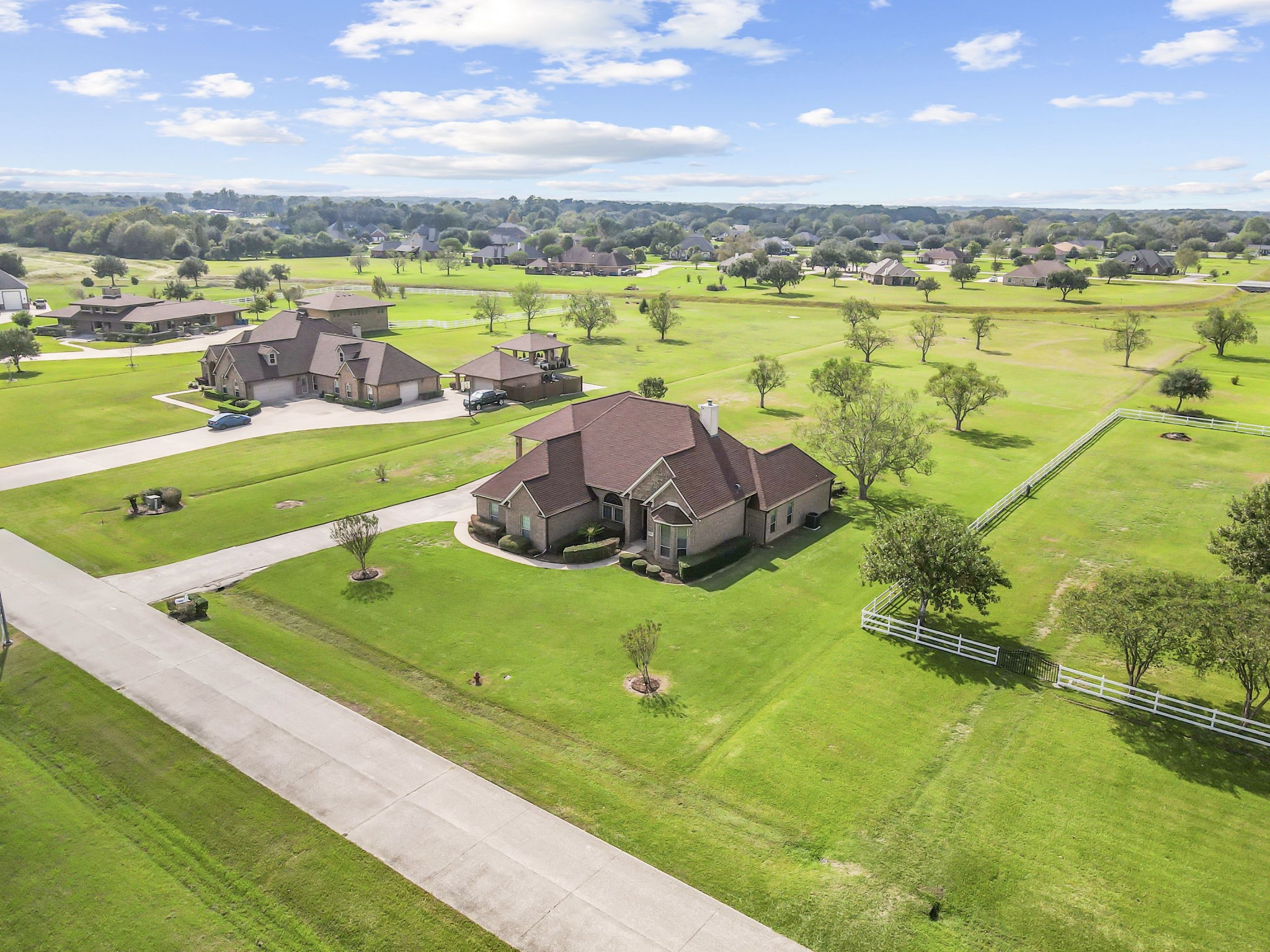 This aerial view highlights the generous spacing between neighboring properties, expansive lawns, and beautiful open surroundings. Situated on over 2 acres, this home offers a wonderful balance of privacy, space, and peaceful country-style living.